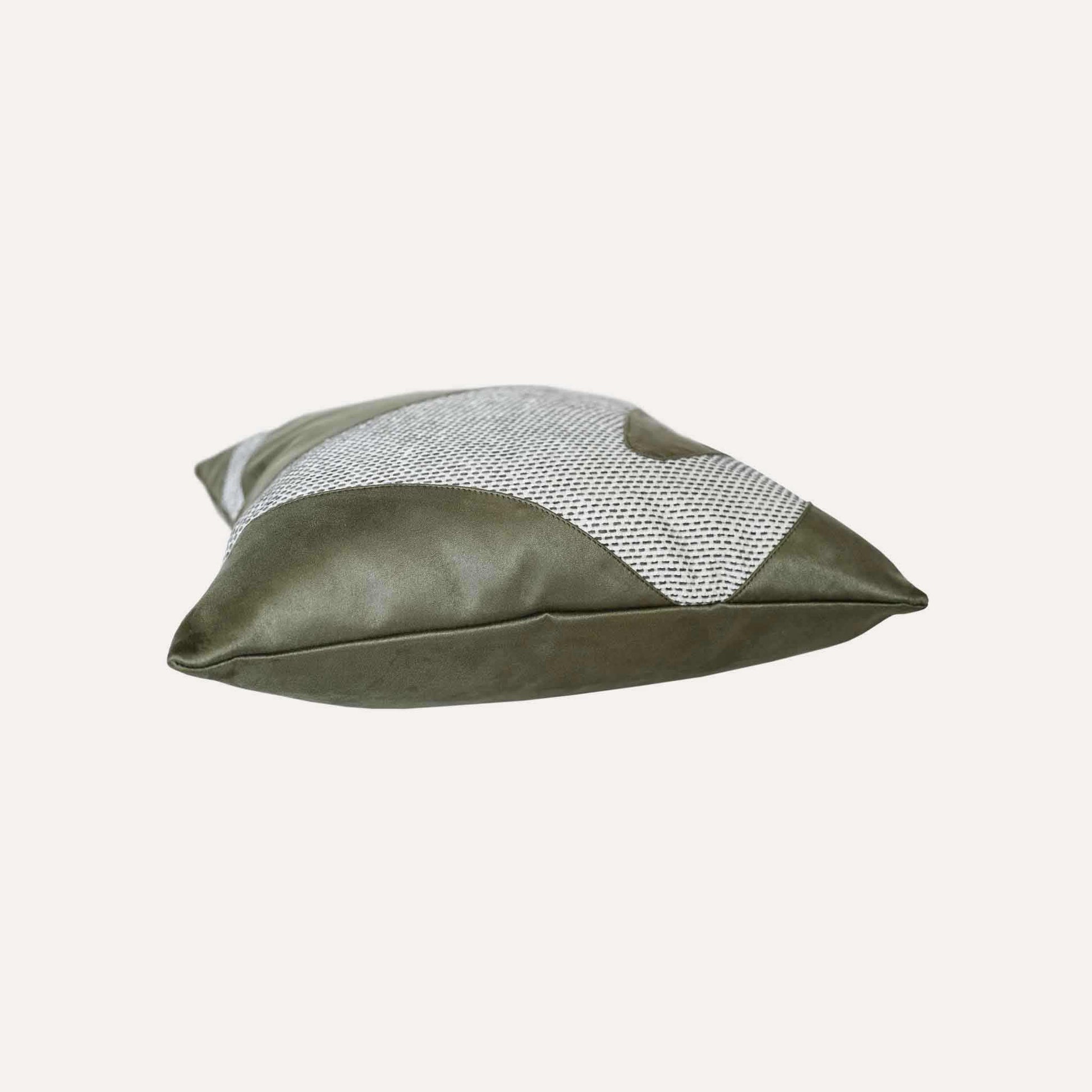 A decorative cushion cover featuring a green and grey irregular splicing design.