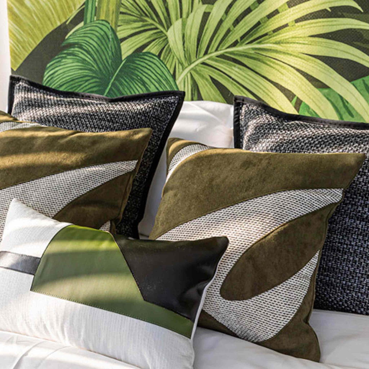 A decorative cushion cover featuring a green and grey irregular splicing design on bed.