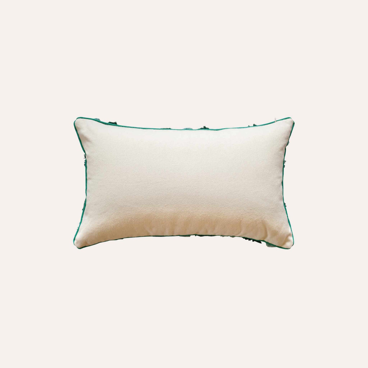 Two-tone turquoise tufted decorative lumbar cushion cover with white back.