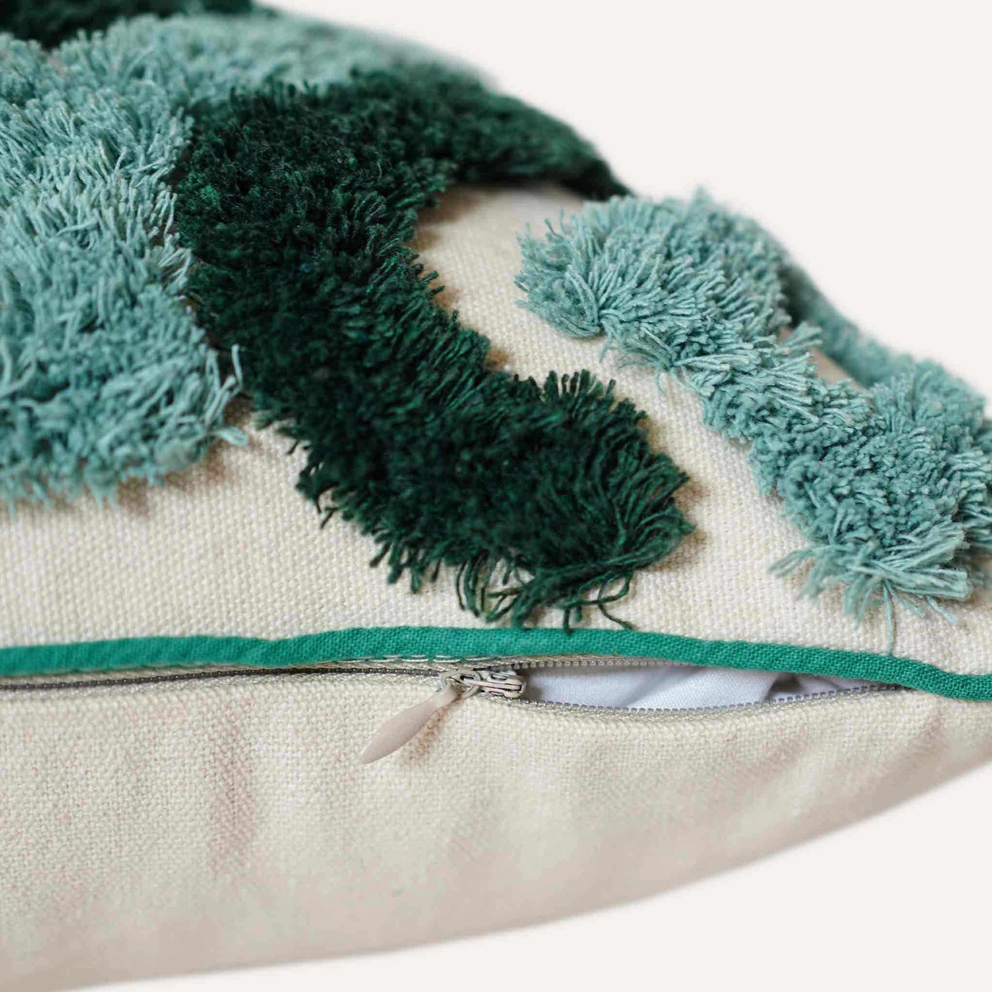 Two-tone turquoise tufted decorative lumbar cushion cover with invisible zipper.