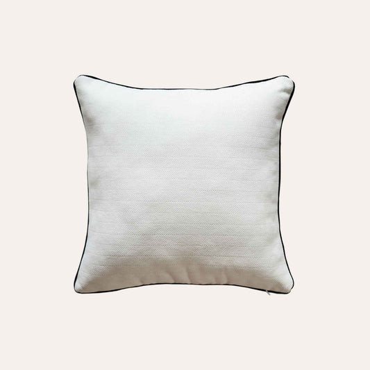 A stylish white cushion cover with black piping, designed with a herringbone texture.