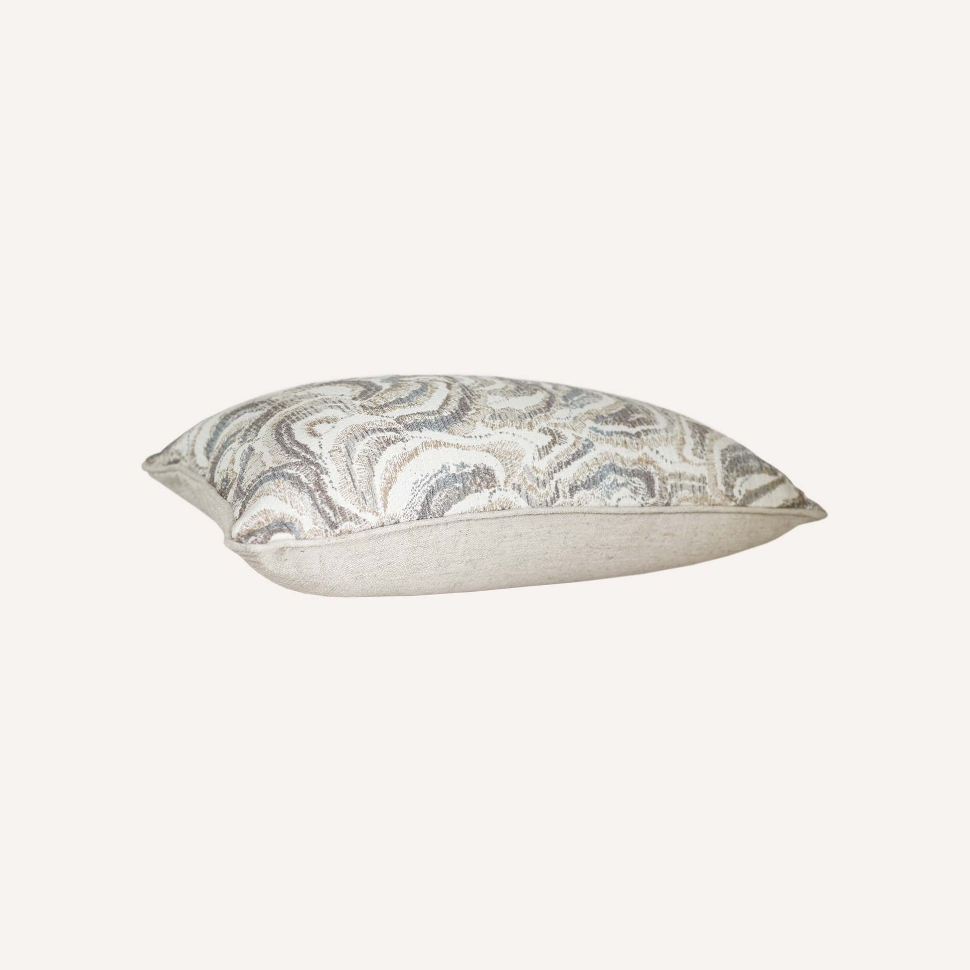 This white and grey mother-of-pearl patterned decorative lumbar cushion adds a contemporary touch to home décor.