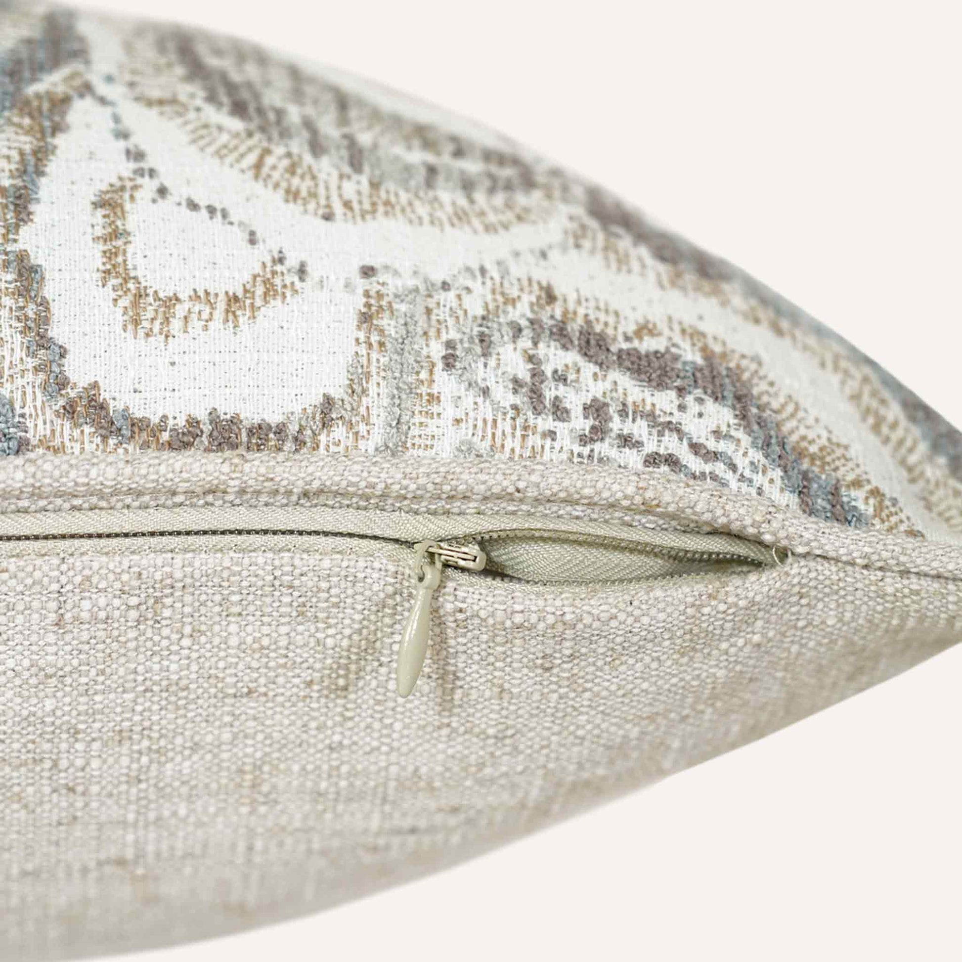 Close-up of the invisible zip on the mother-of-pearl patterned lumbar cushion.