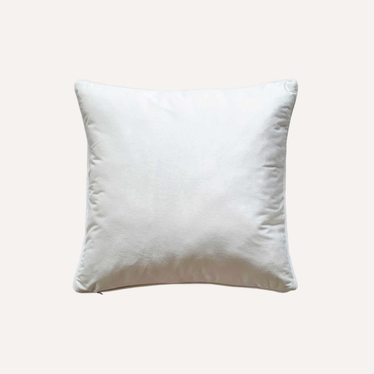 An ivory base cushion cover decorated with blue and yellow colored dots with white back.