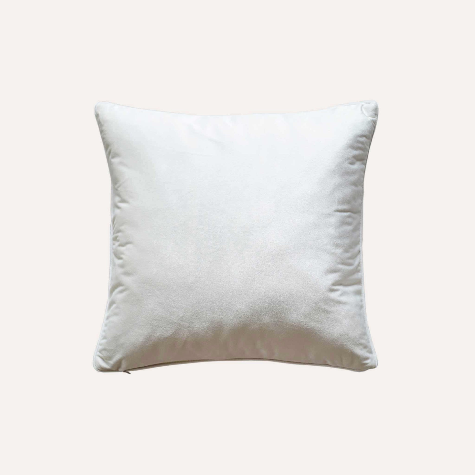 An ivory base cushion cover decorated with blue and yellow colored dots with white back.