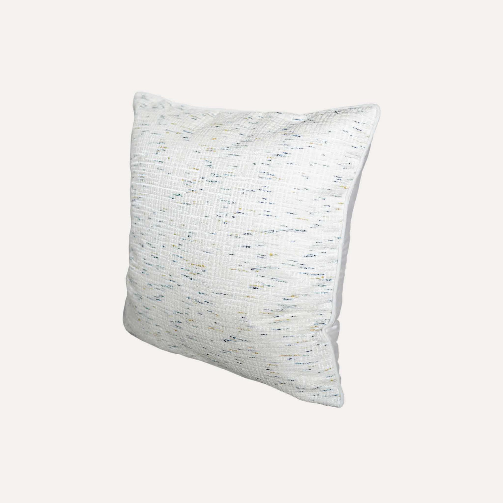 An ivory base cushion cover decorated with blue and yellow colored dots.