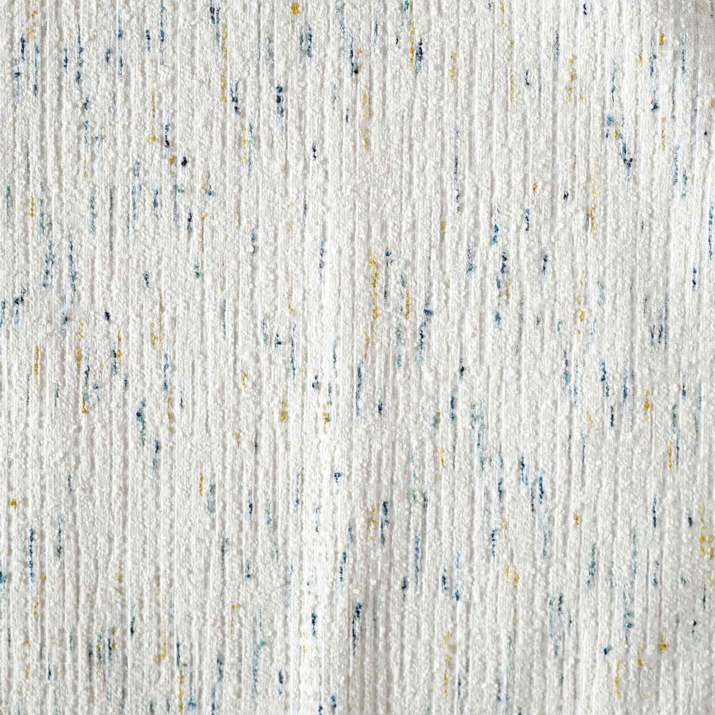 An ivory base cushion cover decorated with blue and yellow colored dots.