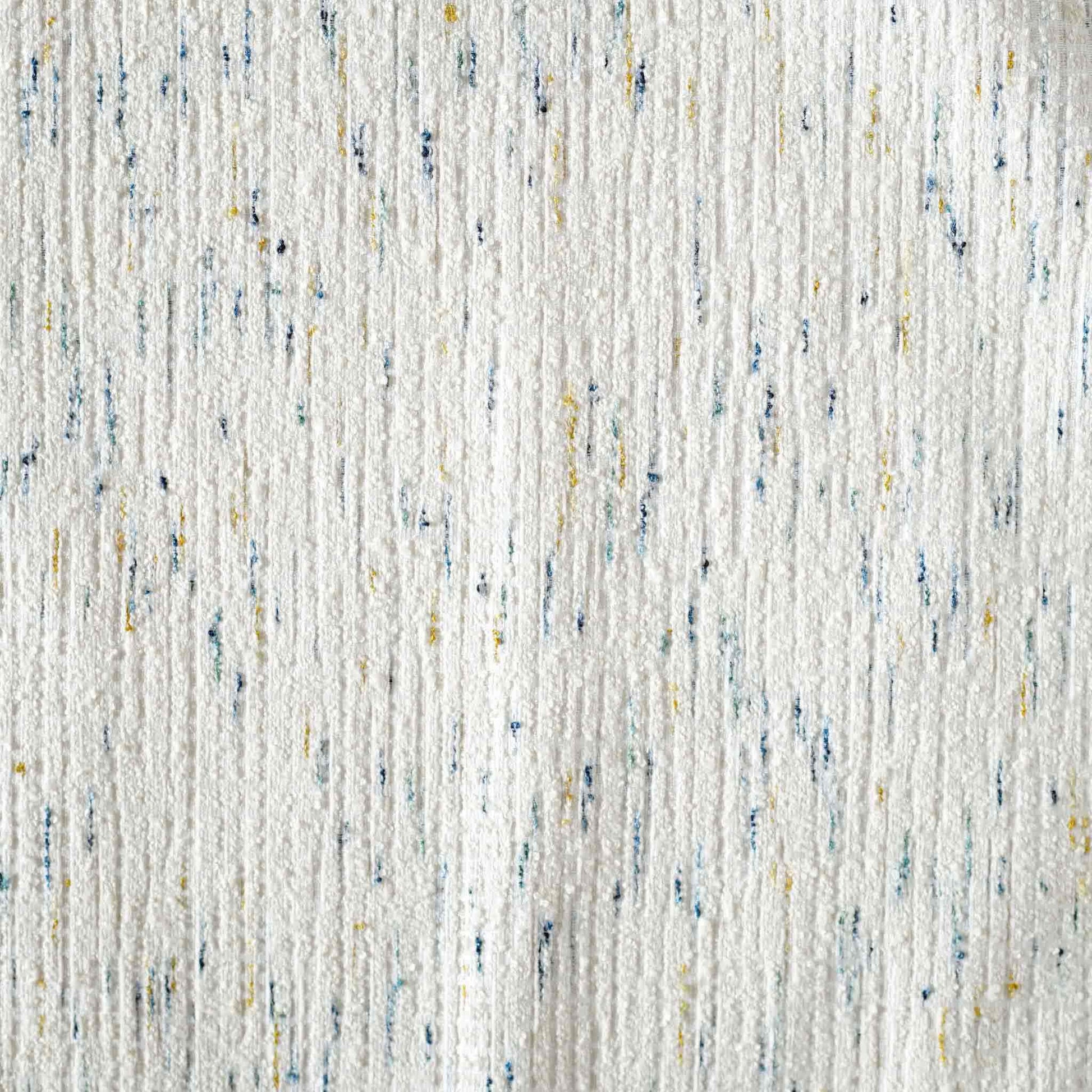 An ivory base cushion cover decorated with blue and yellow colored dots.