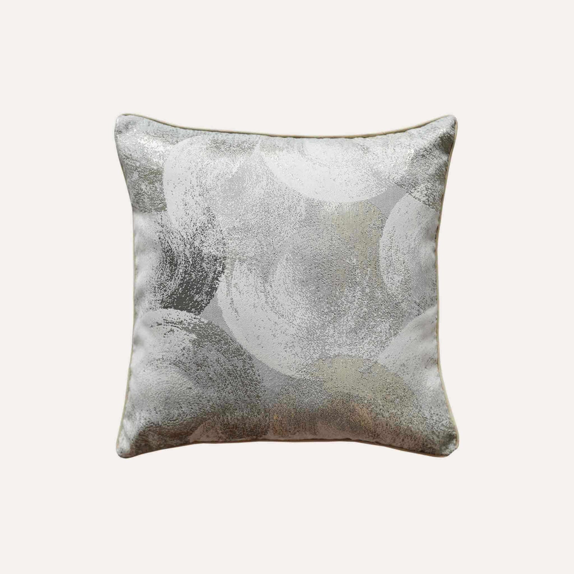 A luxurious silver and grey jacquard cushion cover featuring an abstract design.