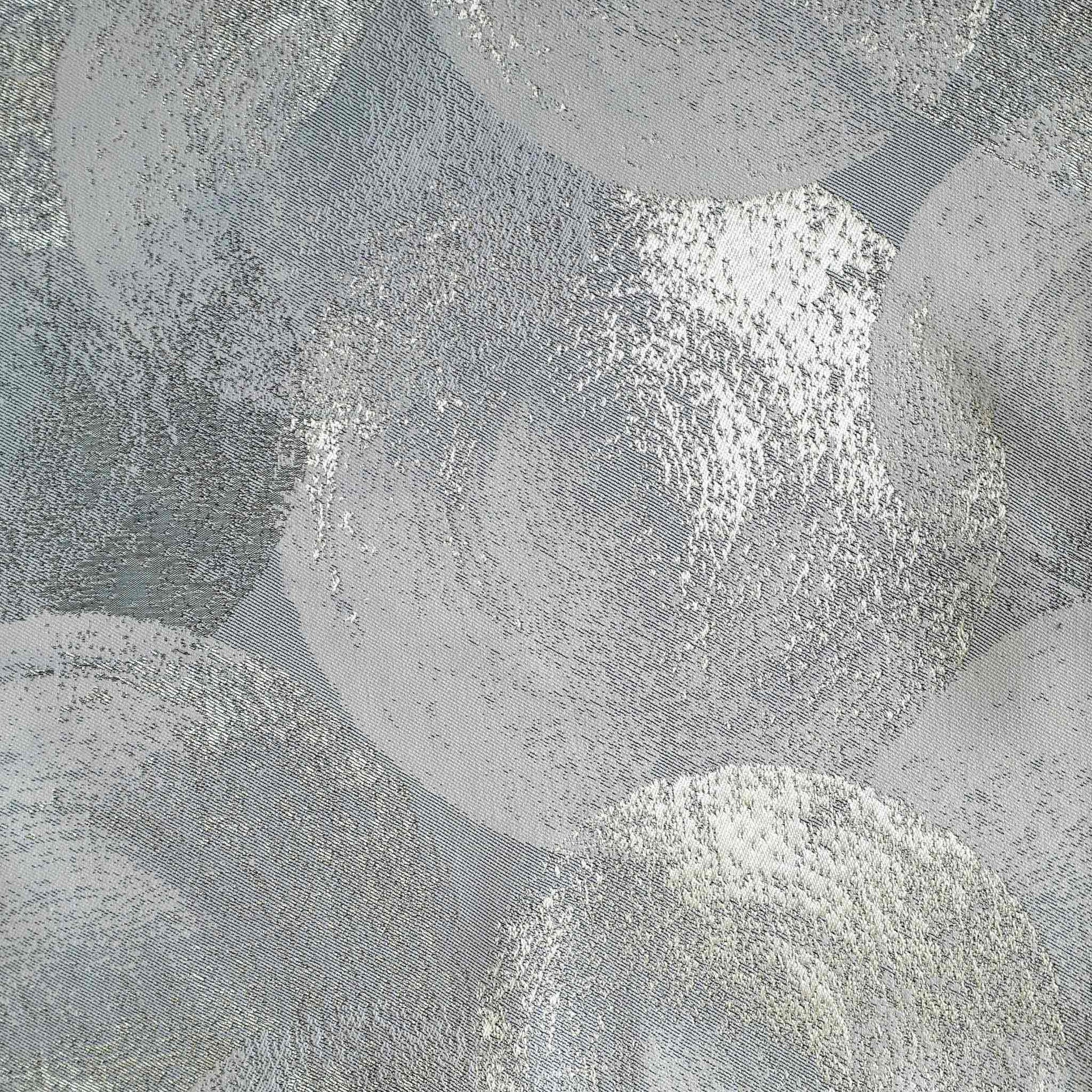A luxurious silver and grey jacquard cushion cover featuring an abstract design.