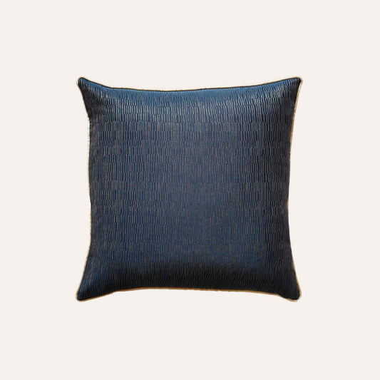 A cushion cover featuring a navy base adorned with delicate gold lines, exuding a sense of luxury.