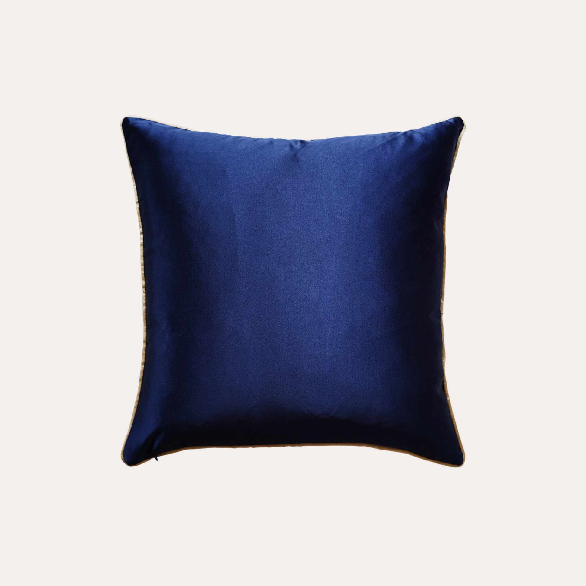 A cushion cover featuring a navy base adorned with delicate gold lines with solid blue back, exuding a sense of luxury.