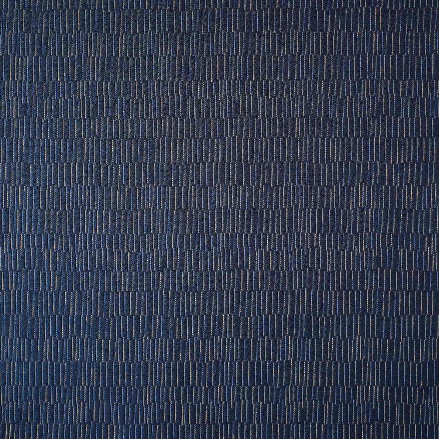 A cushion cover featuring a navy base adorned with delicate gold lines, exuding a sense of luxury.