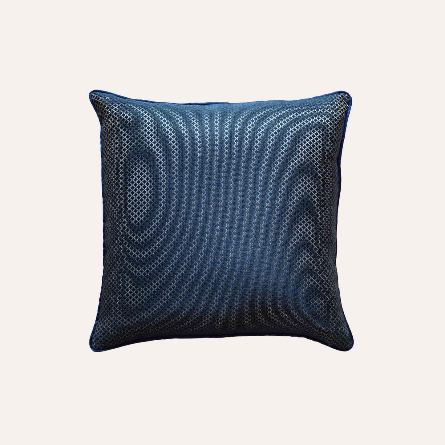 The navy blue cushion cover features subtle gold mesh designs.