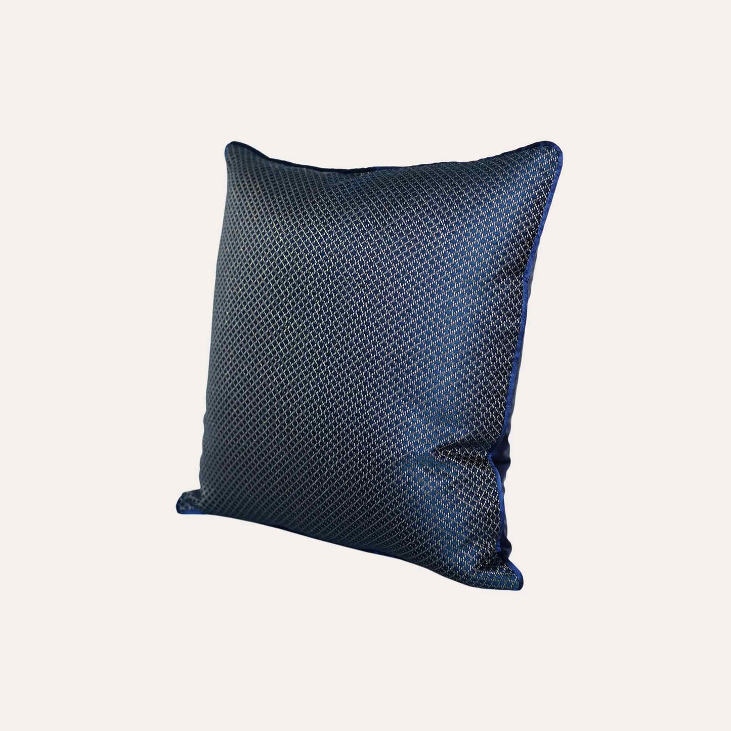 The navy blue cushion cover features subtle gold mesh designs.
