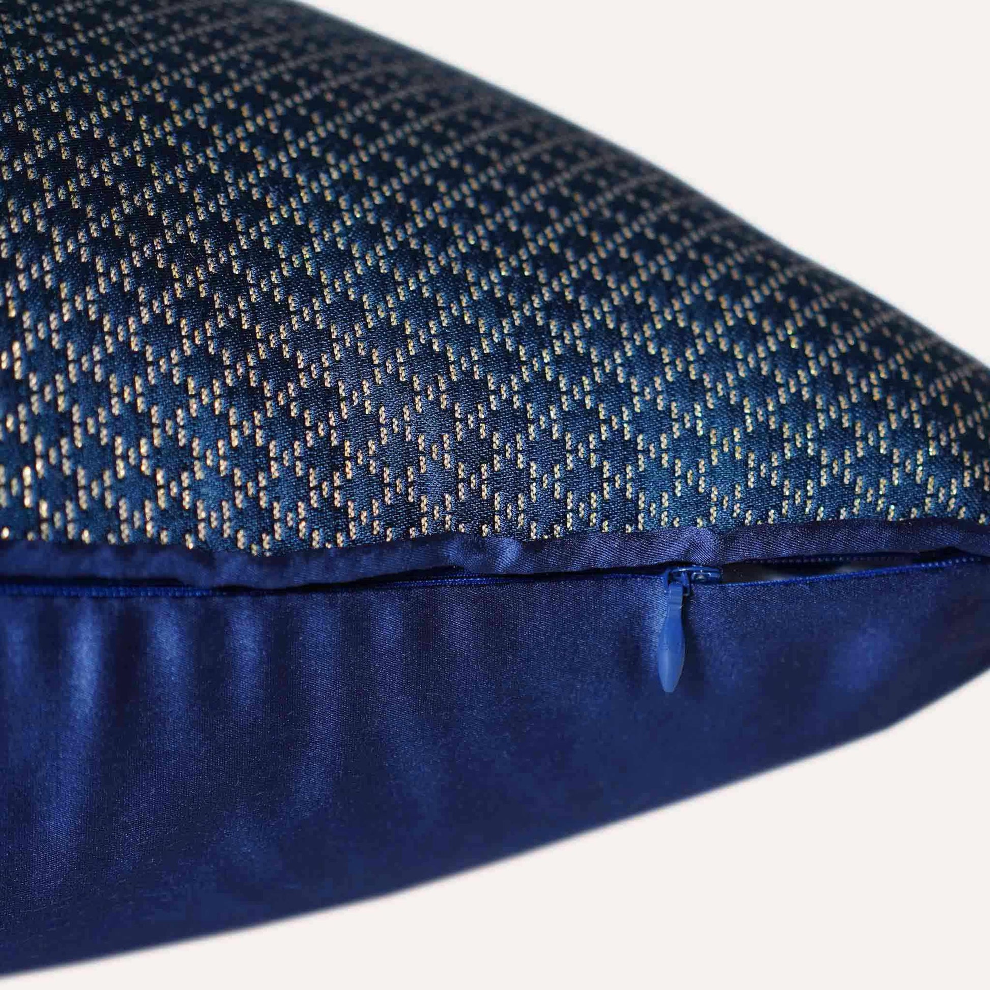 The navy blue cushion cover features subtle gold mesh designs with invisible zipper.