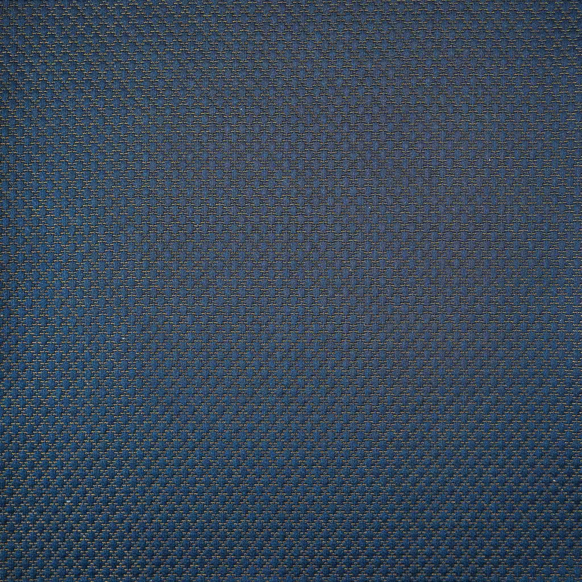 The navy blue cushion cover features subtle gold mesh designs.