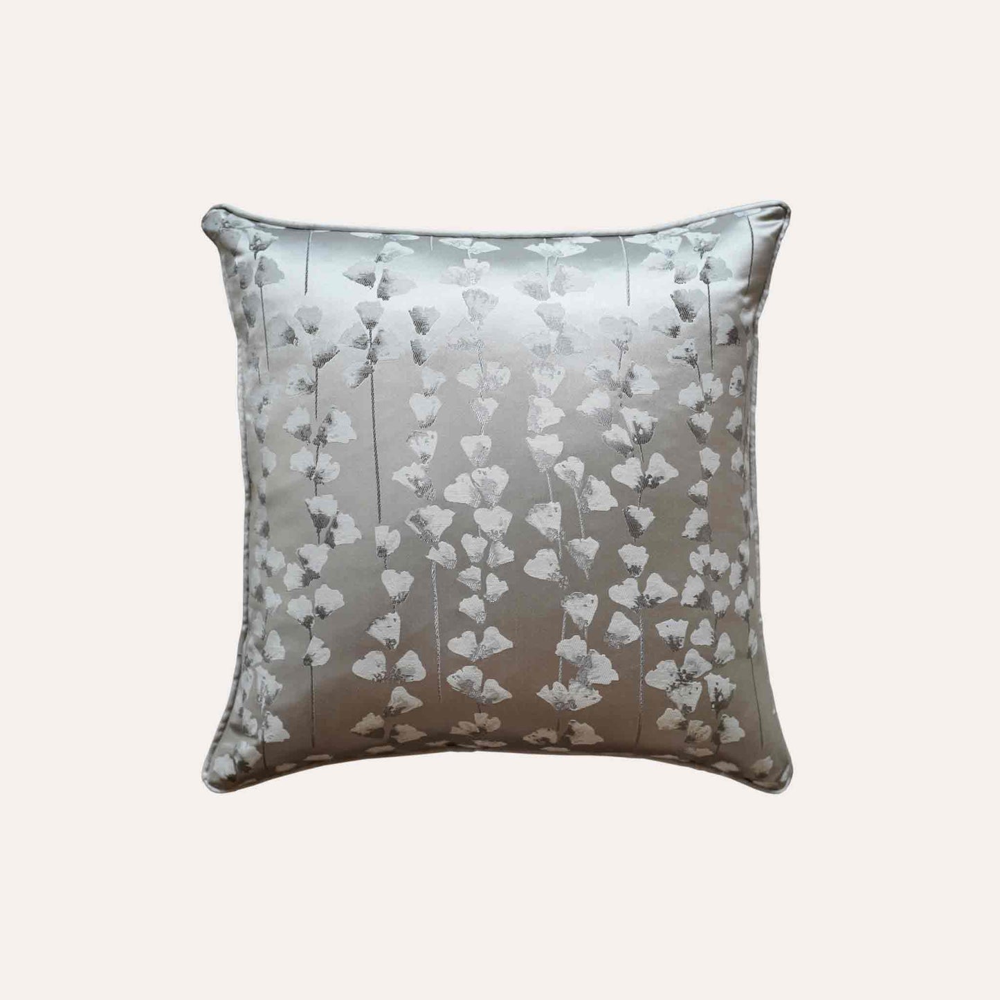 A chic silver cushion cover adorned with intricate off-white jacquard floral designs.