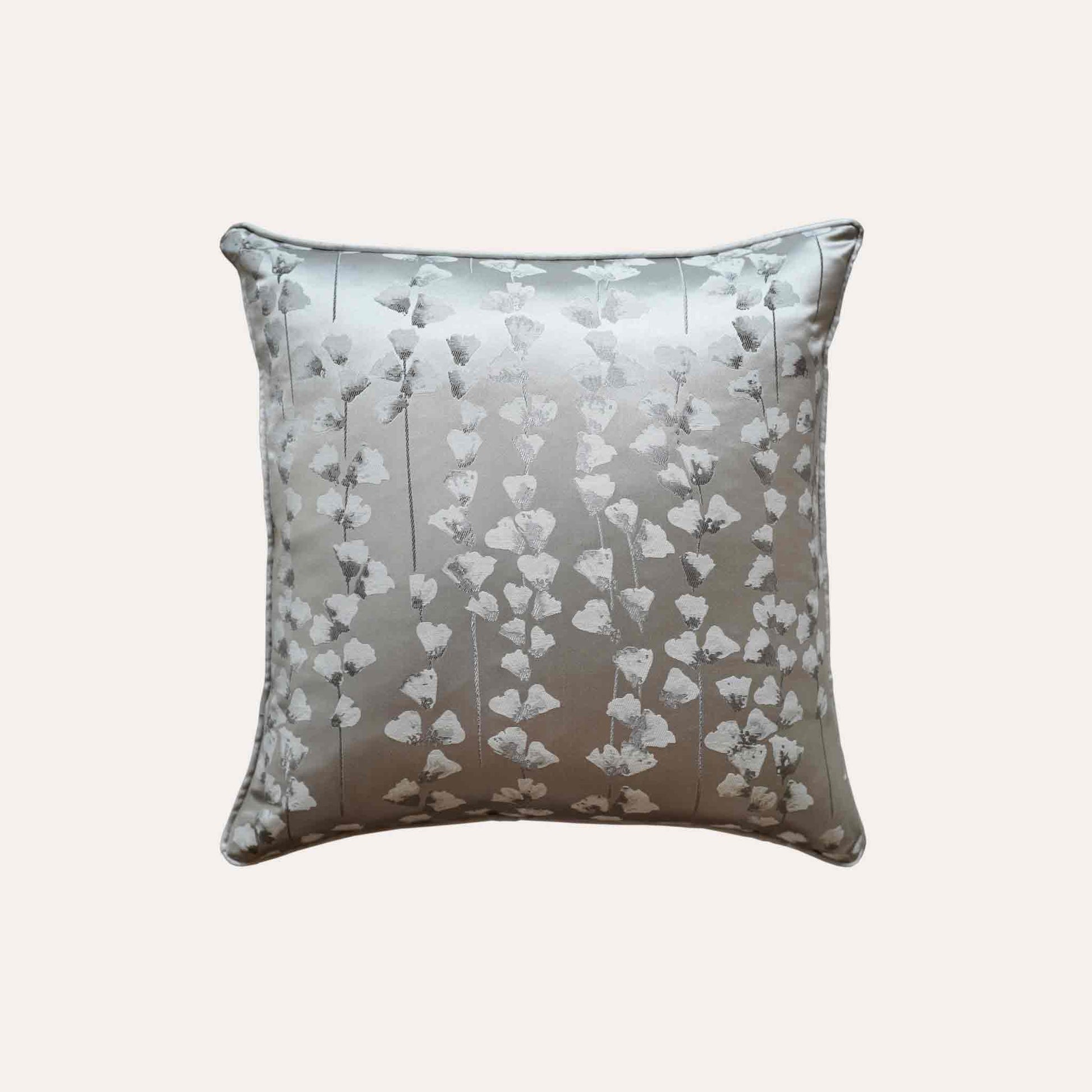 A chic silver cushion cover adorned with intricate off-white jacquard floral designs.