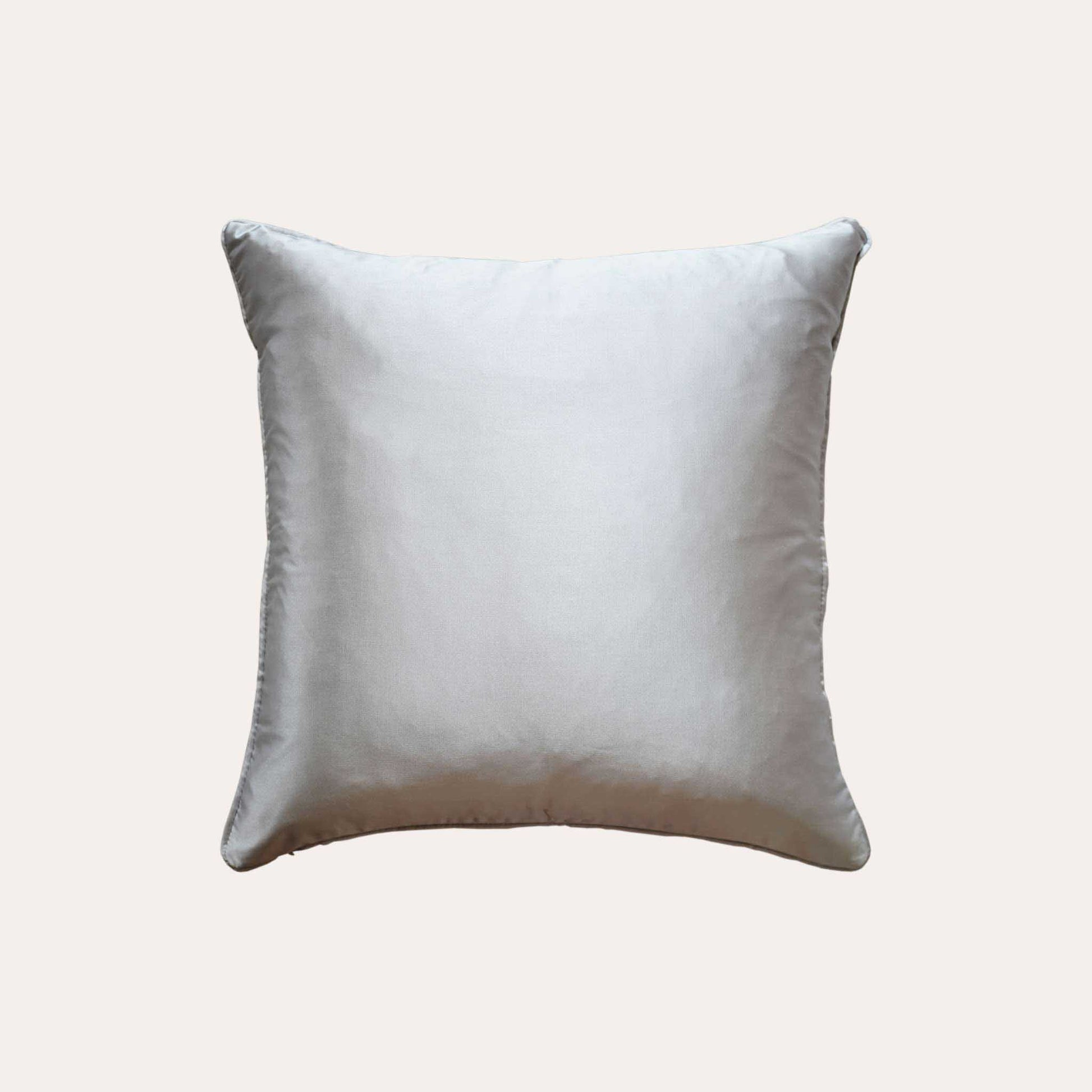 A chic silver cushion cover adorned with intricate off-white jacquard floral designs with sliver back.