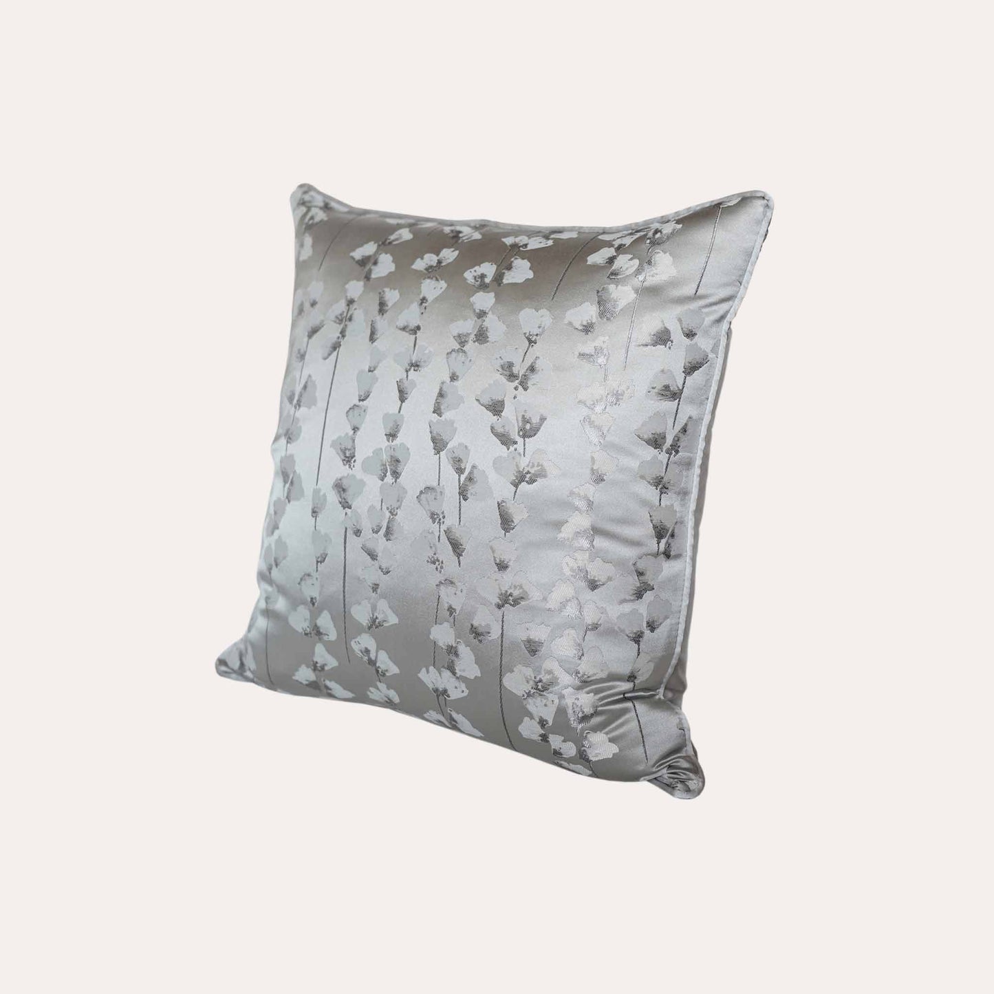 A chic silver cushion cover adorned with intricate off-white jacquard floral designs.
