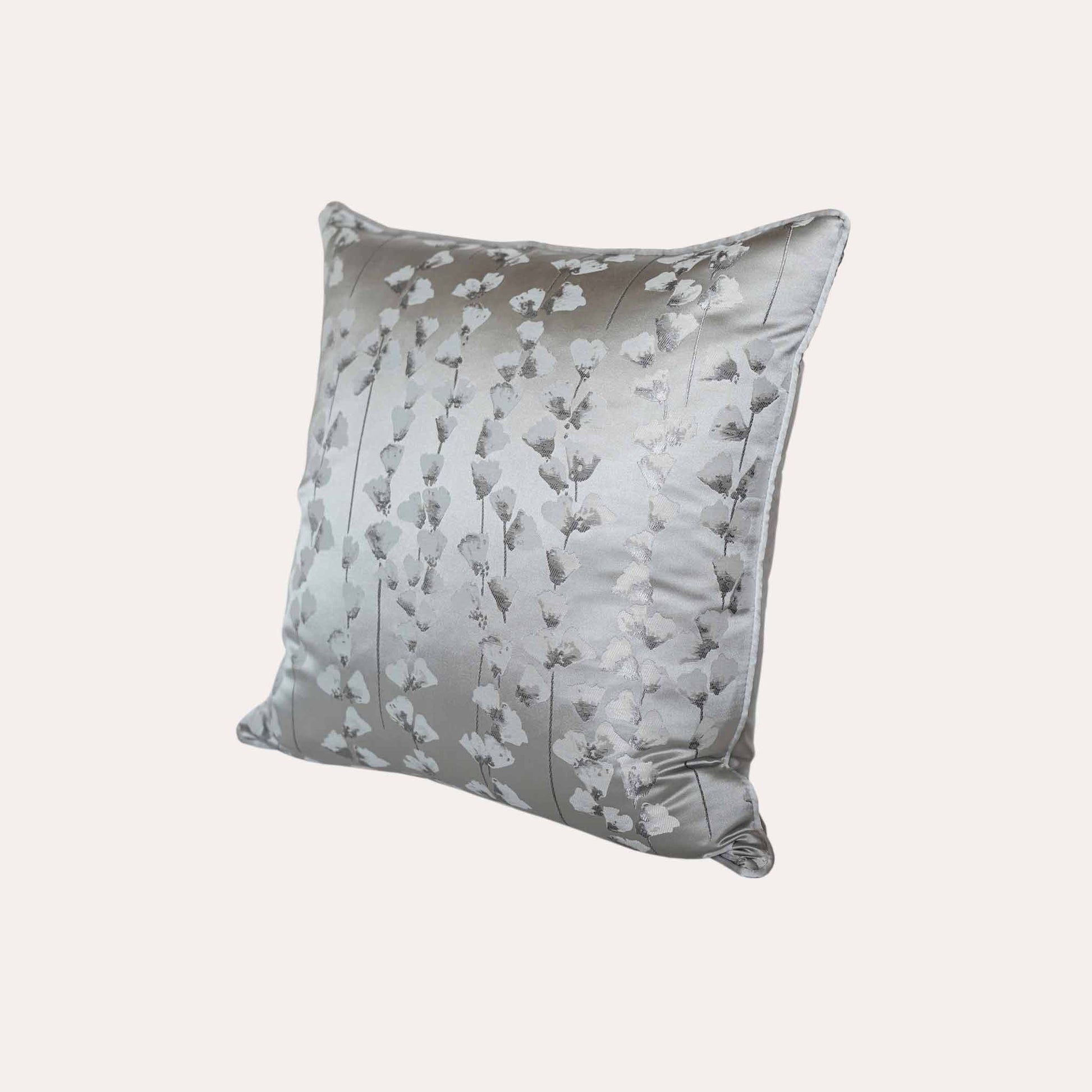 A chic silver cushion cover adorned with intricate off-white jacquard floral designs.
