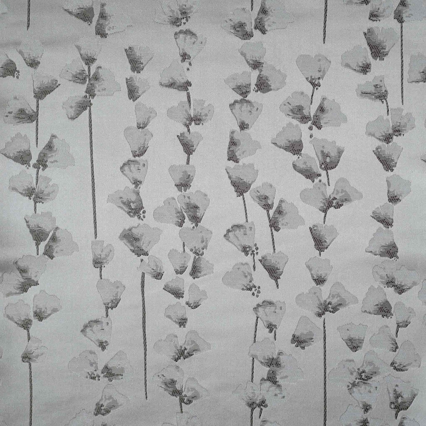 A chic silver cushion cover adorned with intricate off-white jacquard floral designs.