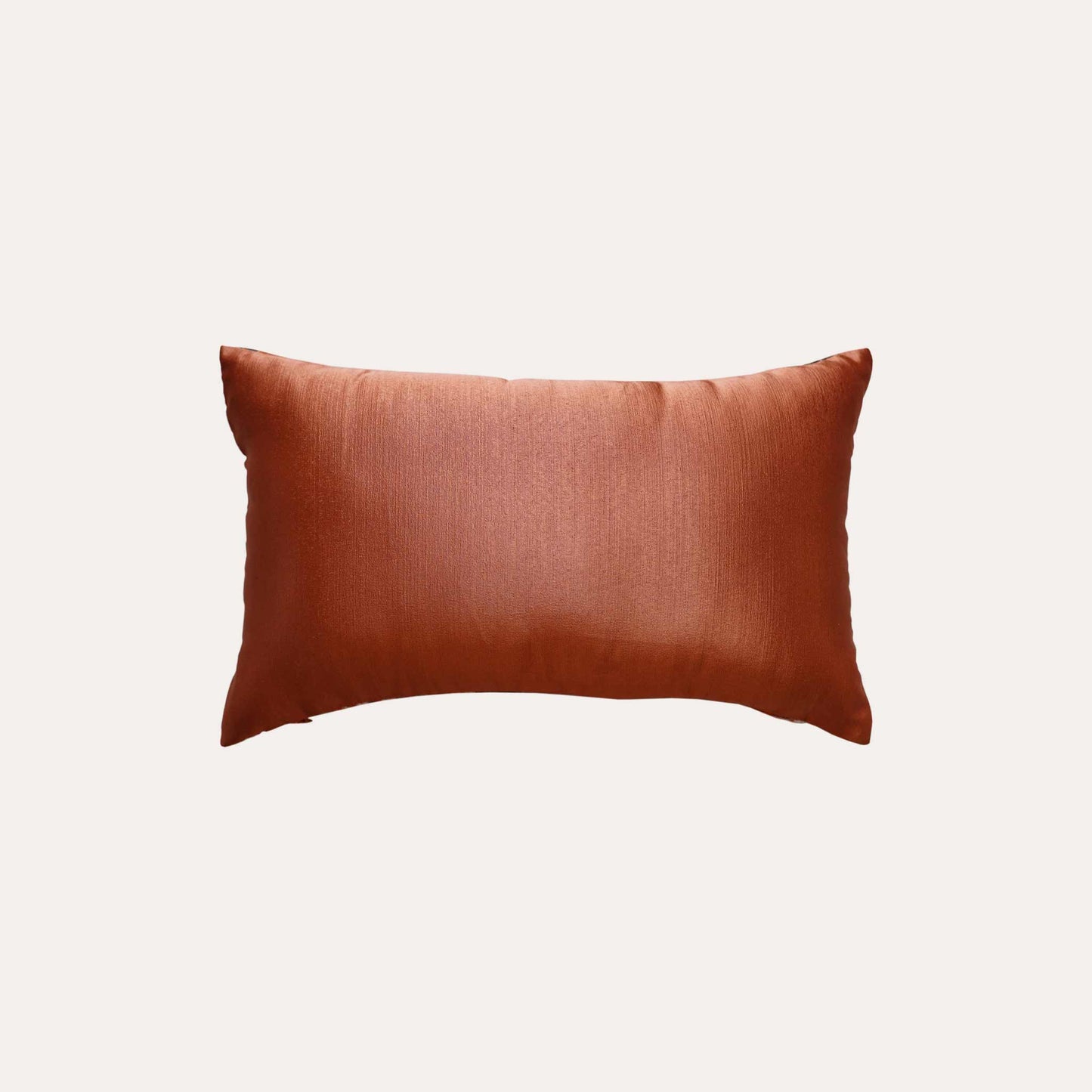 A pattern resembling orange, green, and white feathers on the lumbar cushion cover with orange back.