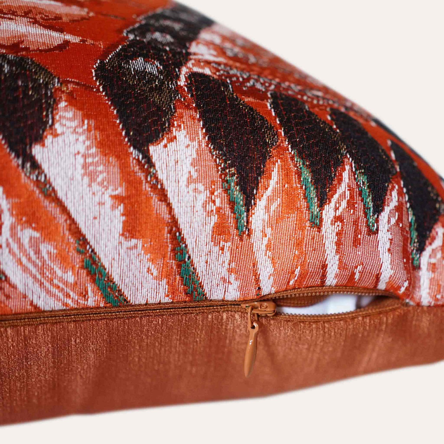 A pattern resembling orange, green, and white feathers on the lumbar cushion cover with invisible zipper.