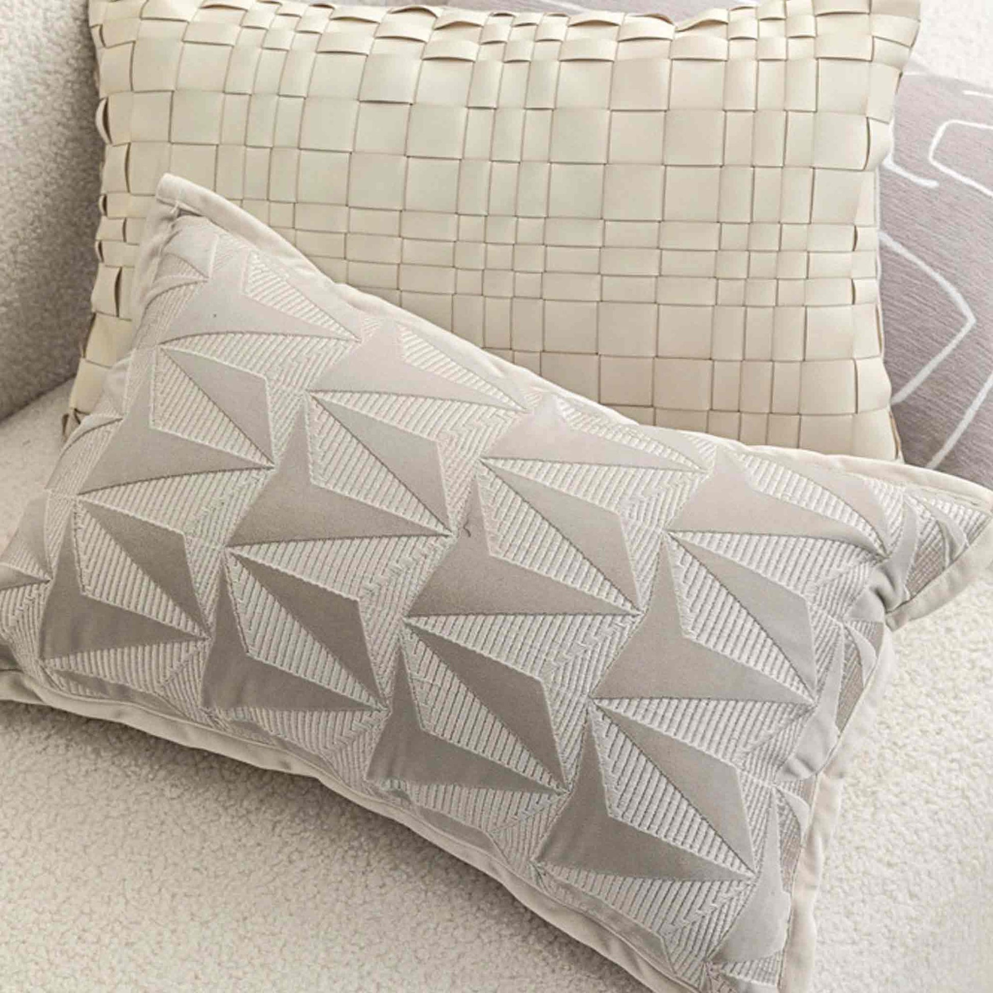 Luxury silver-grey texture geometric pattern lumbar cushion cover on sofa.
