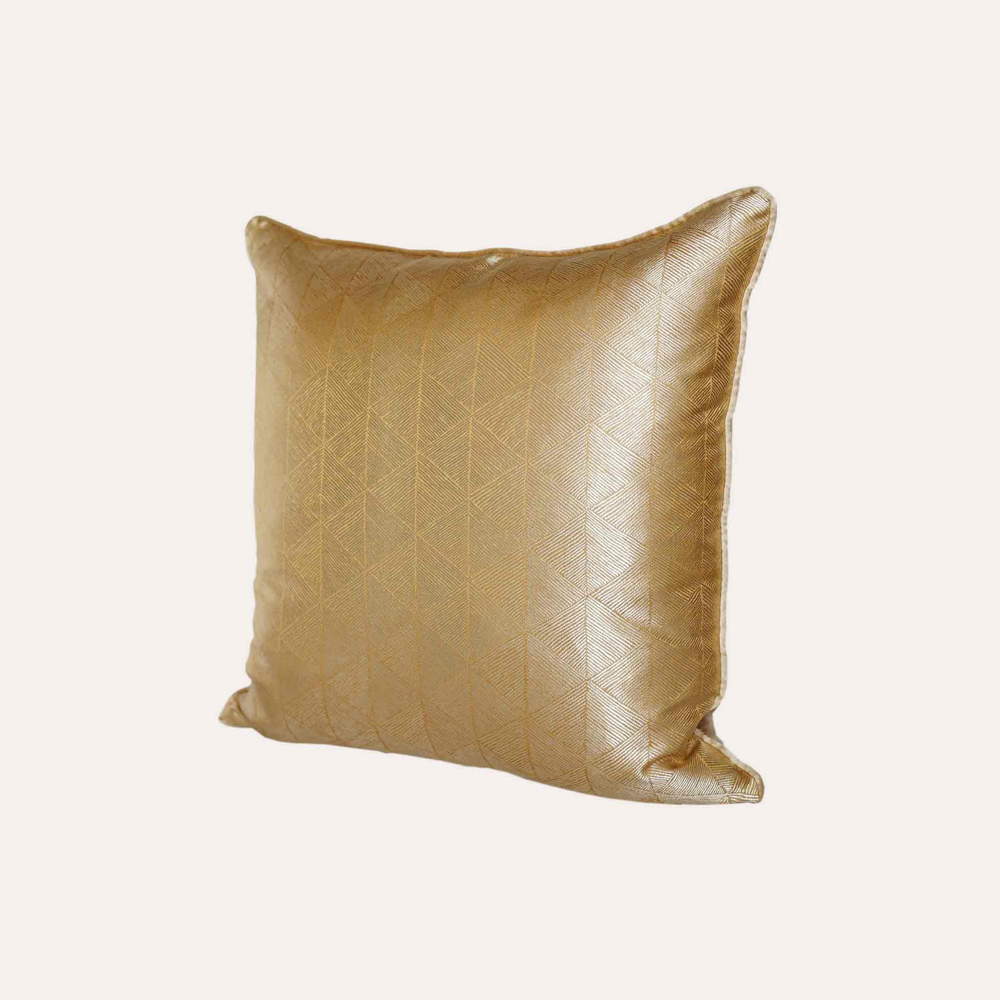 Luxurious gold accent cushion cover in a striking geometric triangle pattern.