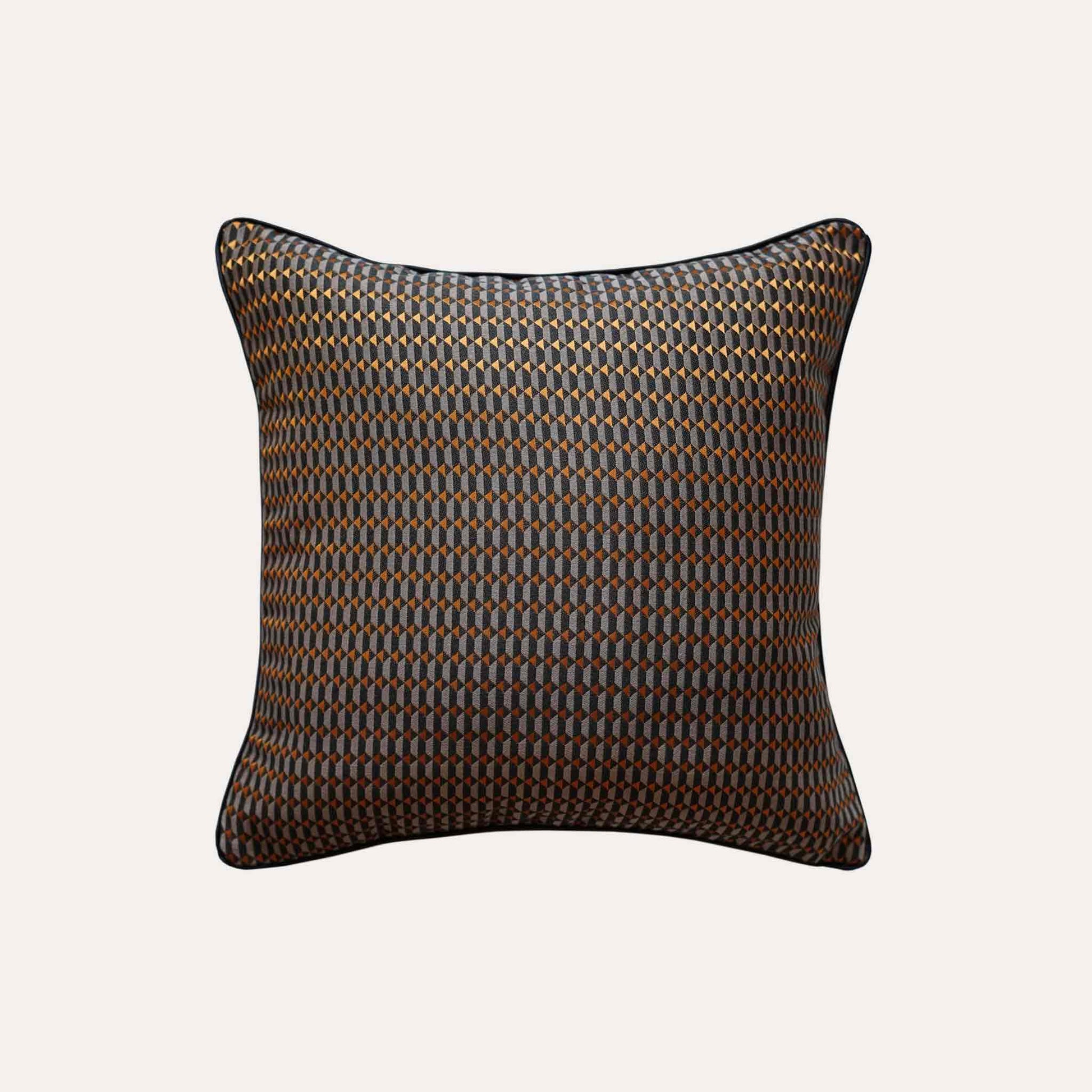 Contemporary cushion covers with a bold black and orange 3D geometric design.