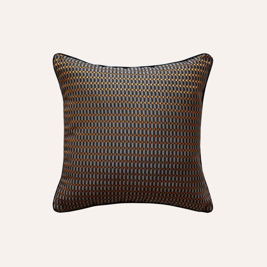 Contemporary cushion covers with a bold black and orange 3D geometric design.