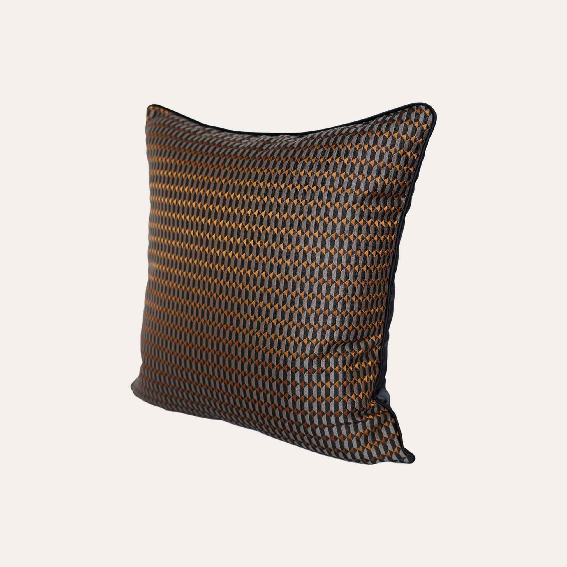 Contemporary cushion covers with a bold black and orange 3D geometric design