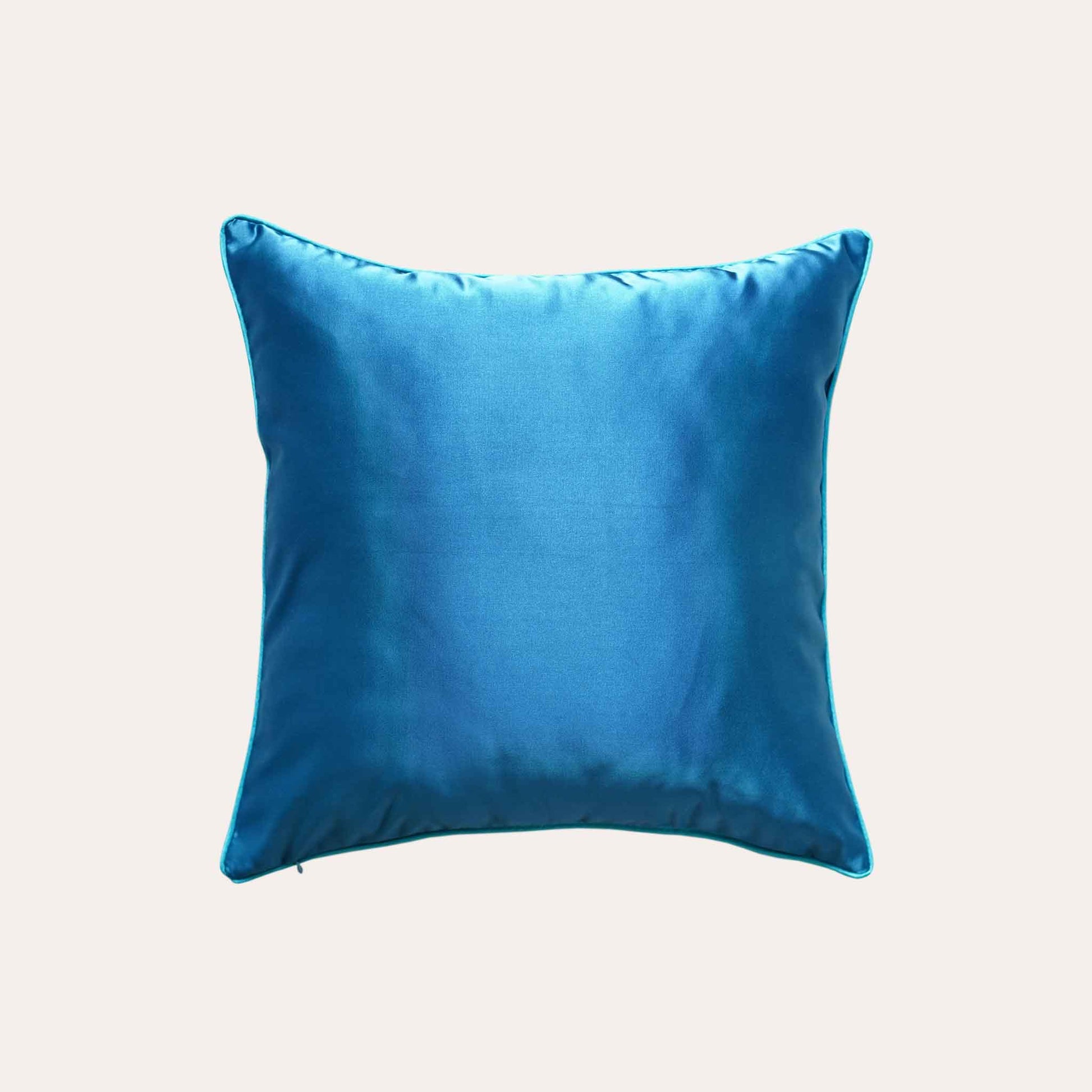 A blue sliver decorative cushion featuring a modern geometric circles pattern with solid blue back.