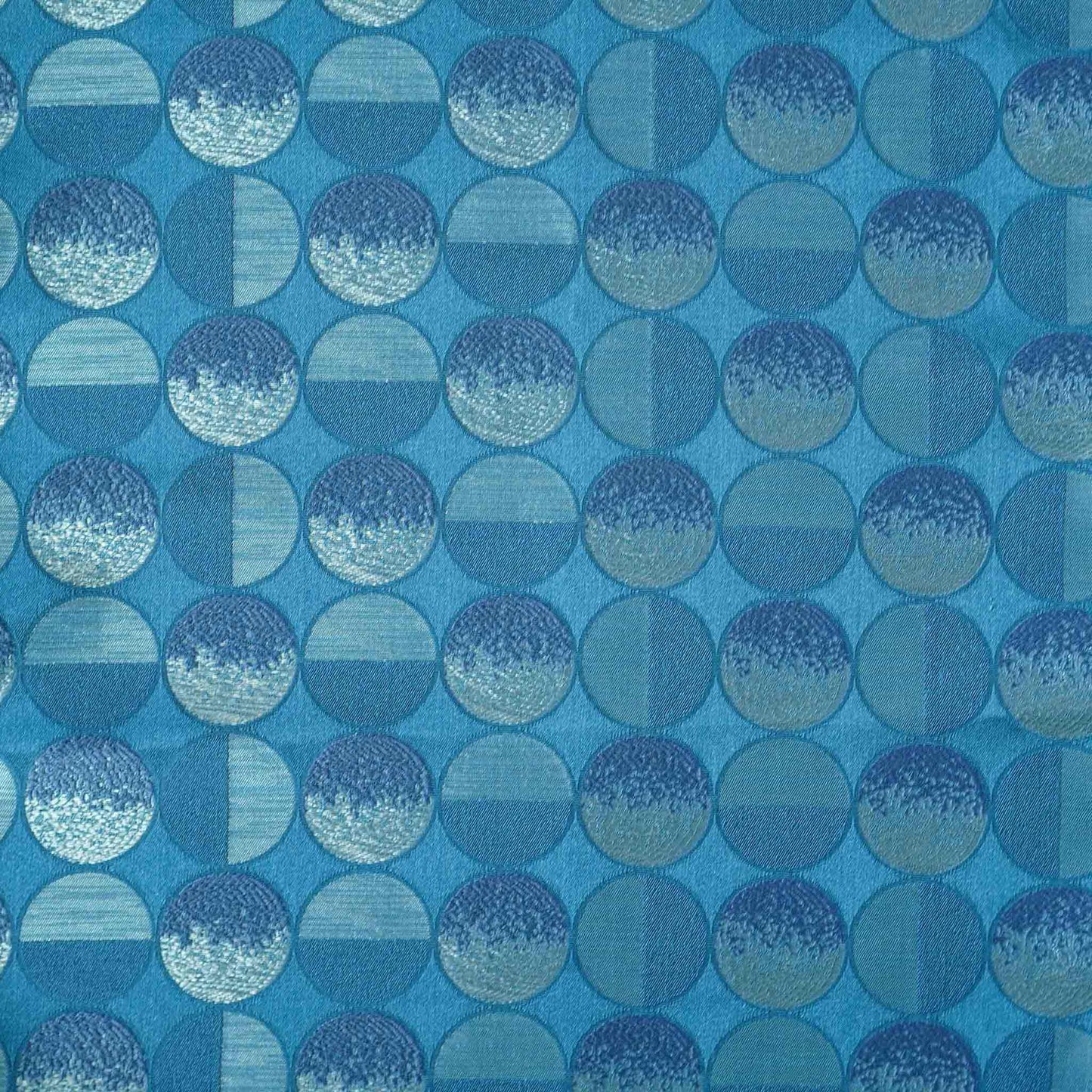 A blue sliver decorative cushion featuring a modern geometric circles pattern.