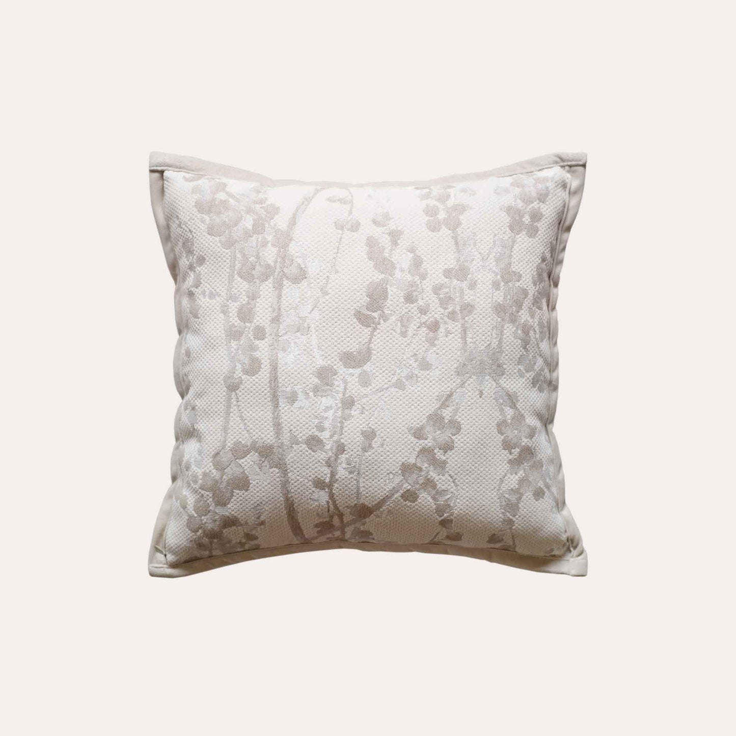 Beige chenille cushion covers with oatmeal vine pattern.