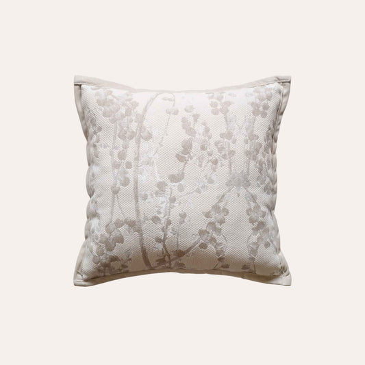 Beige chenille cushion covers with oatmeal vine pattern.