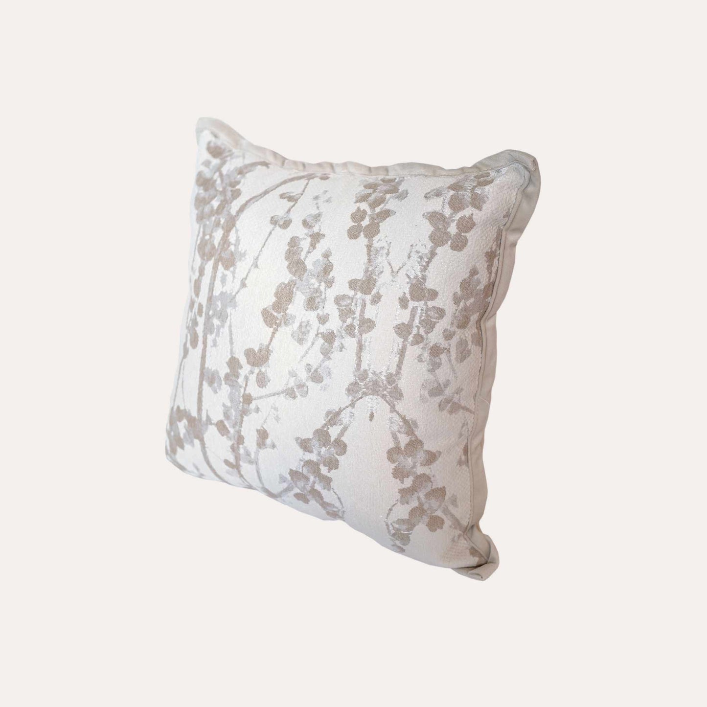 Beige chenille cushion covers with oatmeal vine pattern.