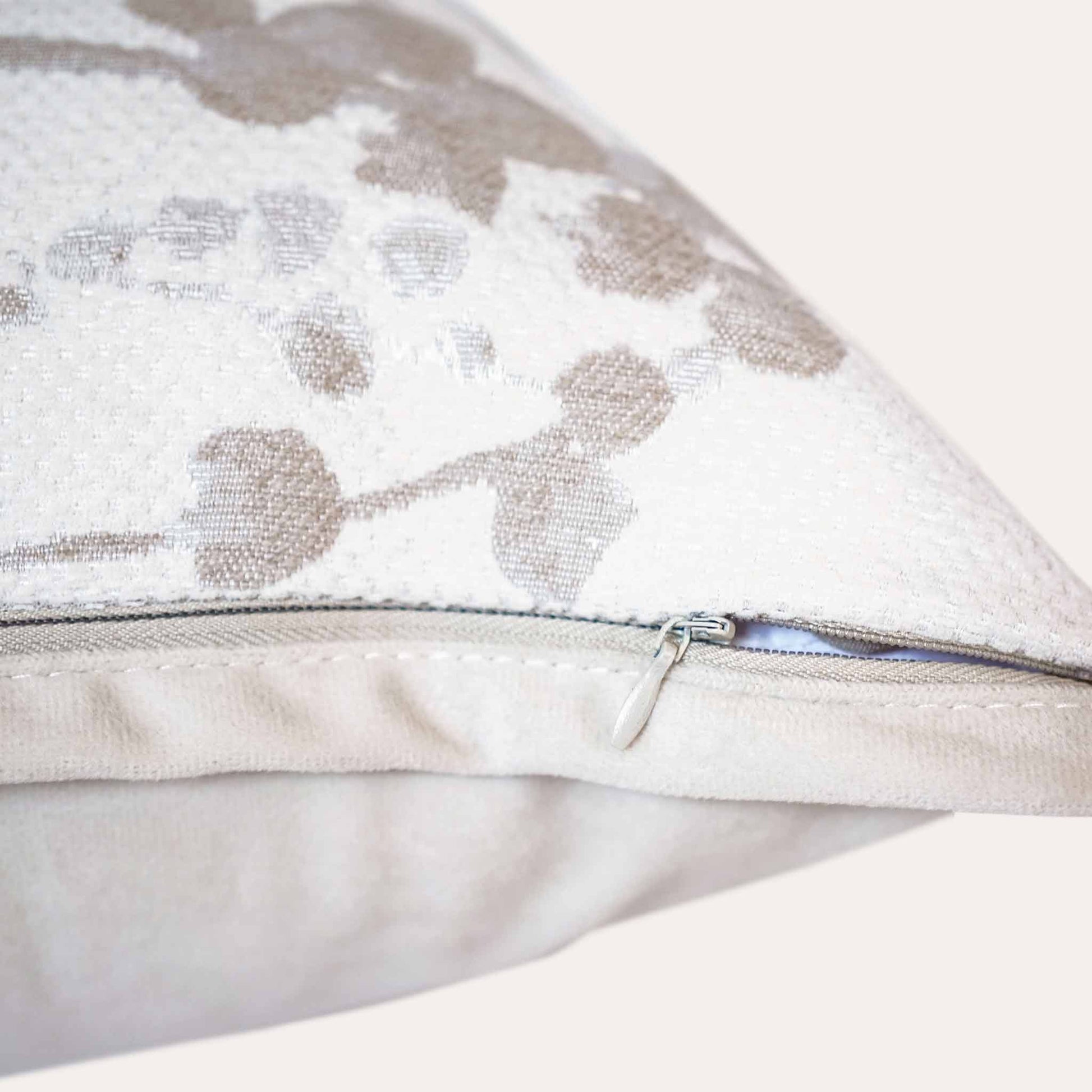 Beige vine pattern chenille cushion covers with invisible zipper.
