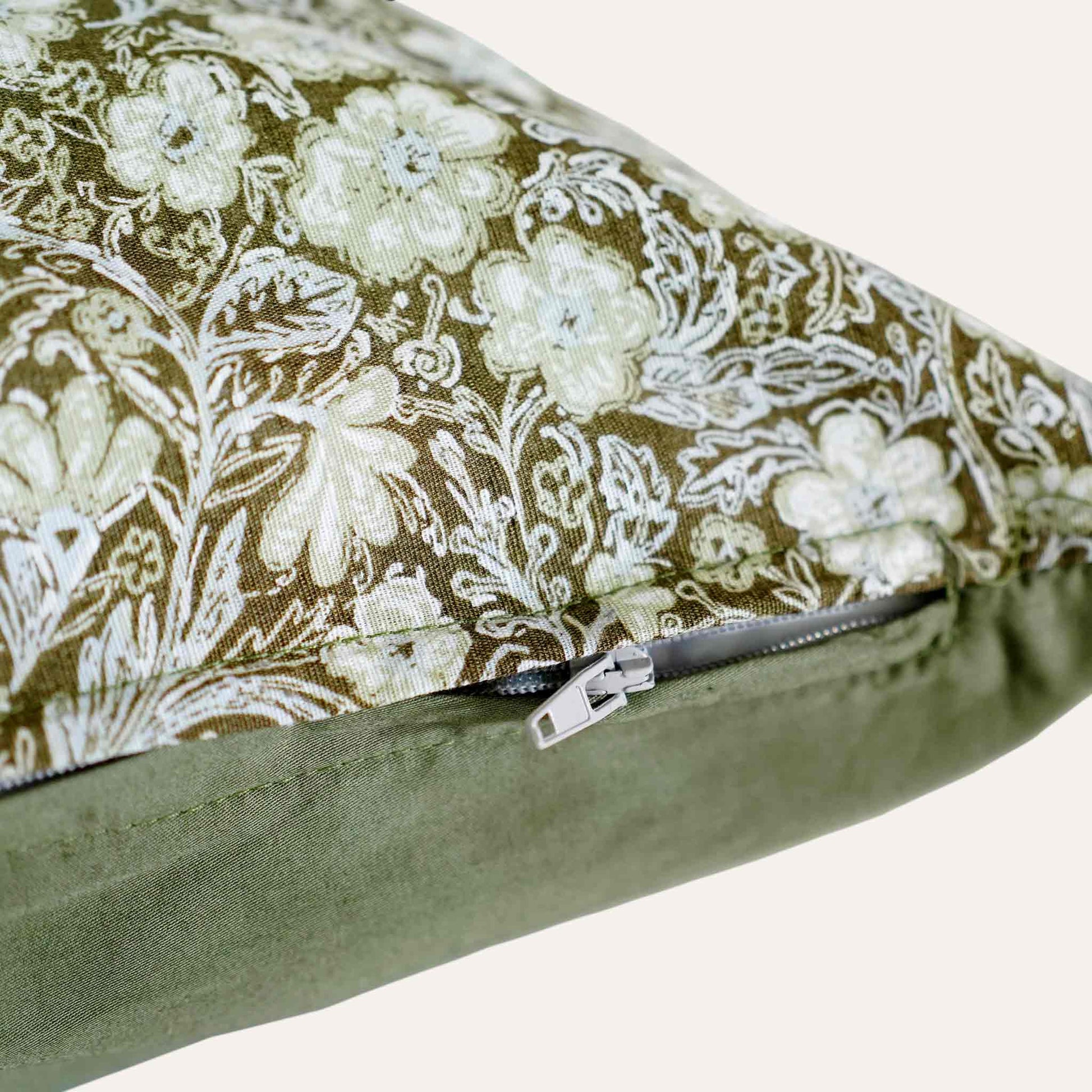 Close-up of the invisible zip on the floral pattern olive bottom waist cushion.