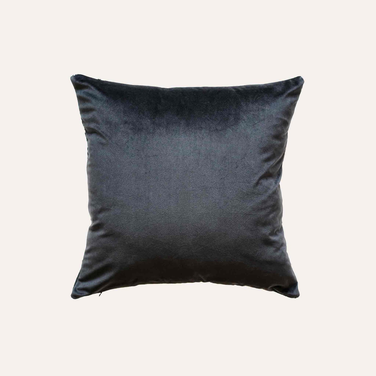 A black and white plaid and ribbon cushion cover with black back.