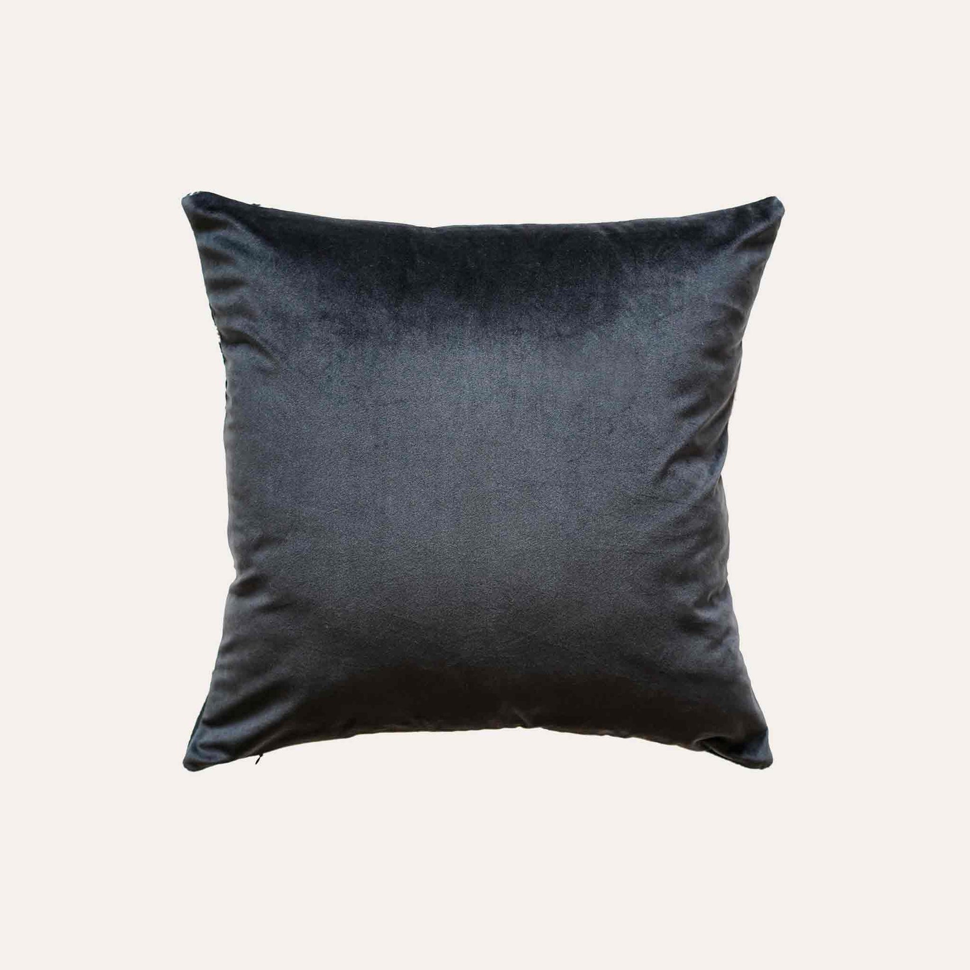 A black and white plaid and ribbon cushion cover with black back.