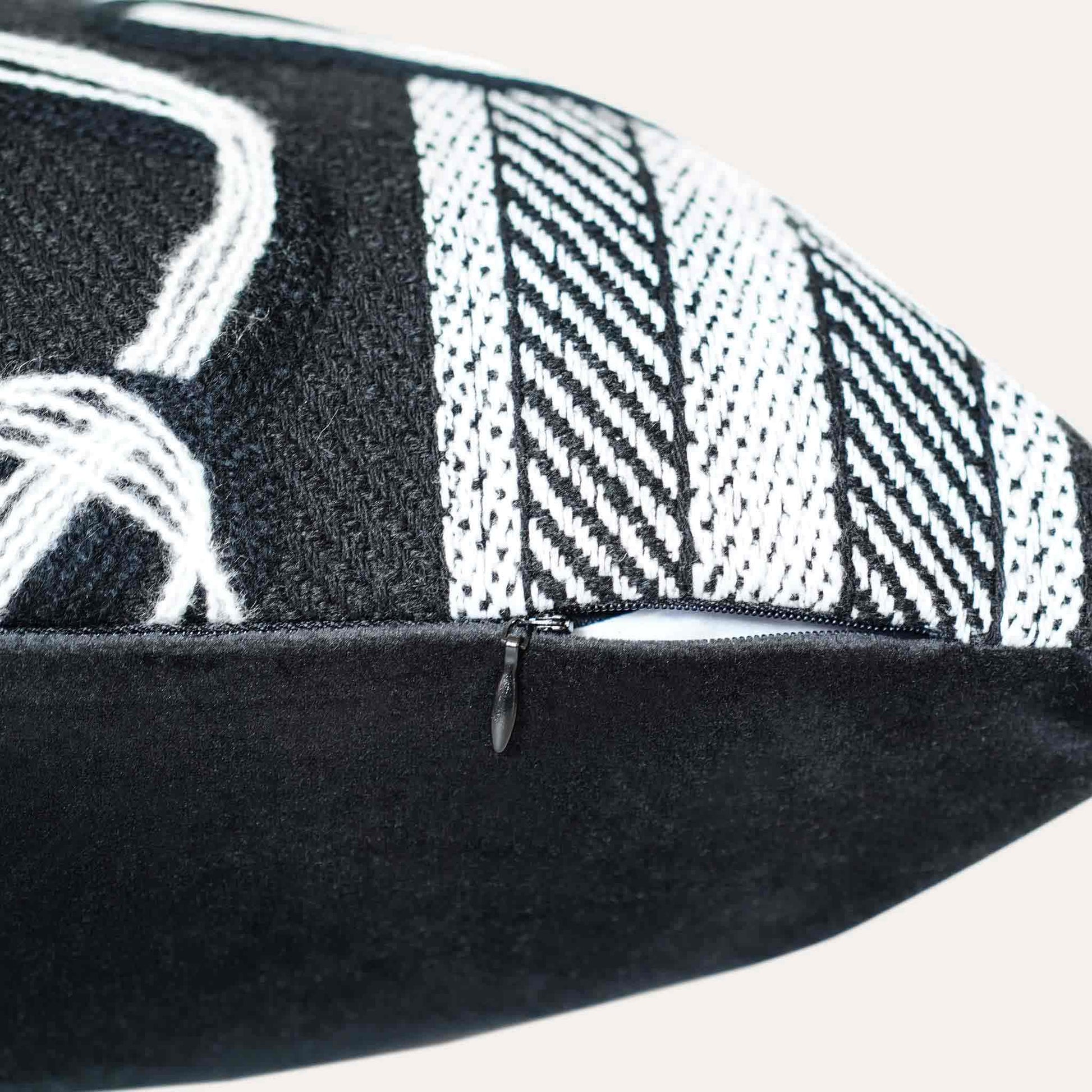 A black and white plaid and ribbon cushion cover with invisible zipper.