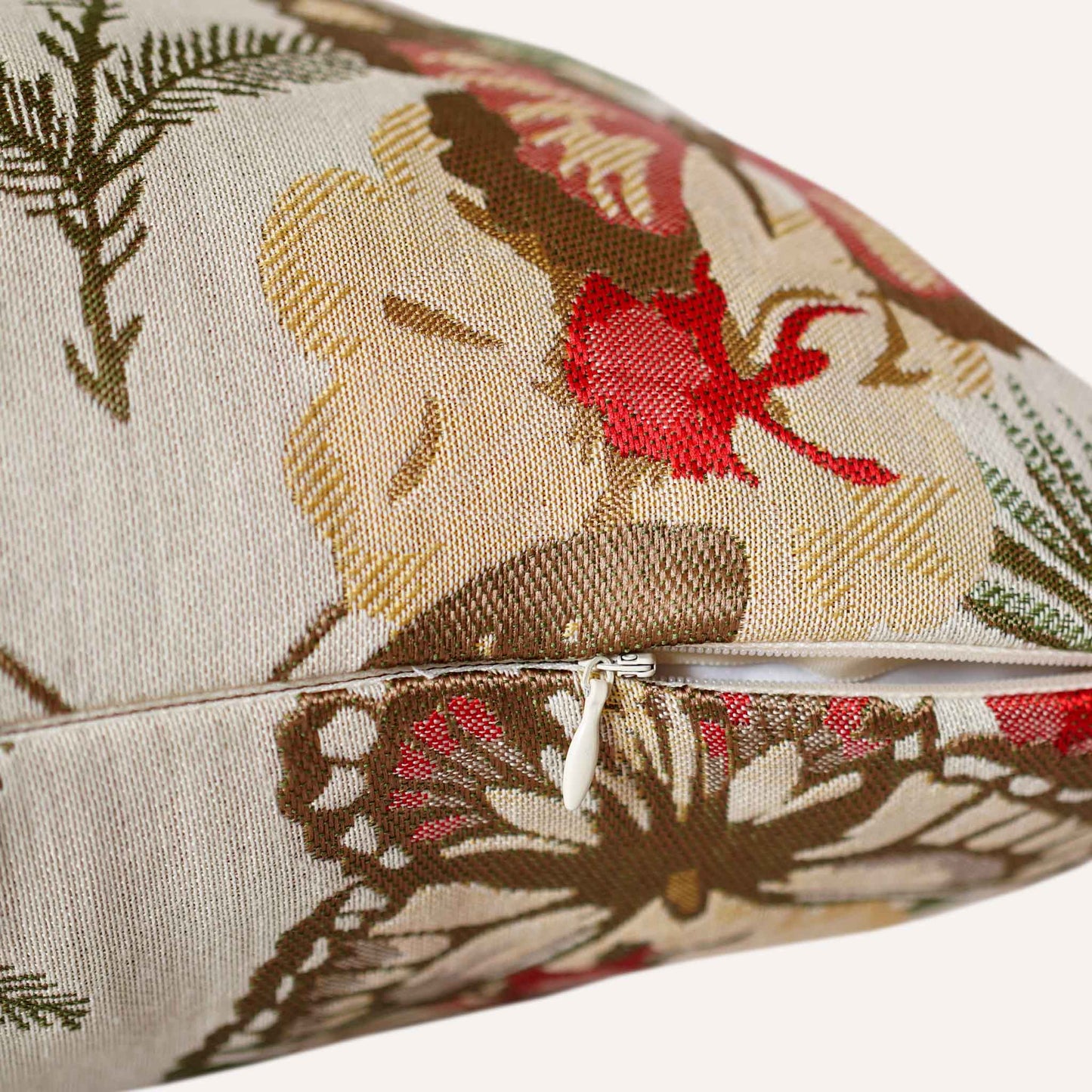 Close-up of the invisible zip on the red butterfly and floral cushion.