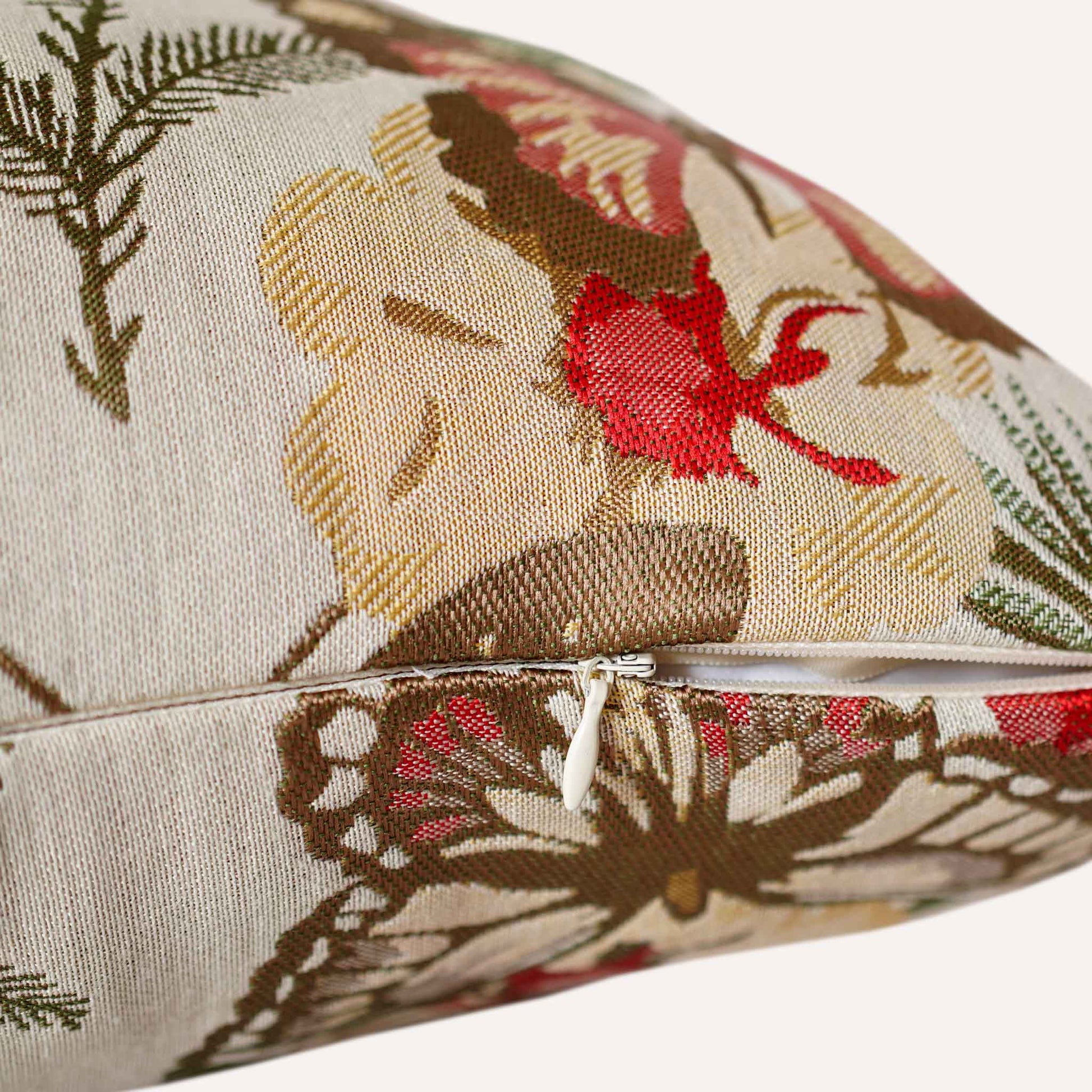 Close-up of the invisible zip on the red butterfly and floral cushion.