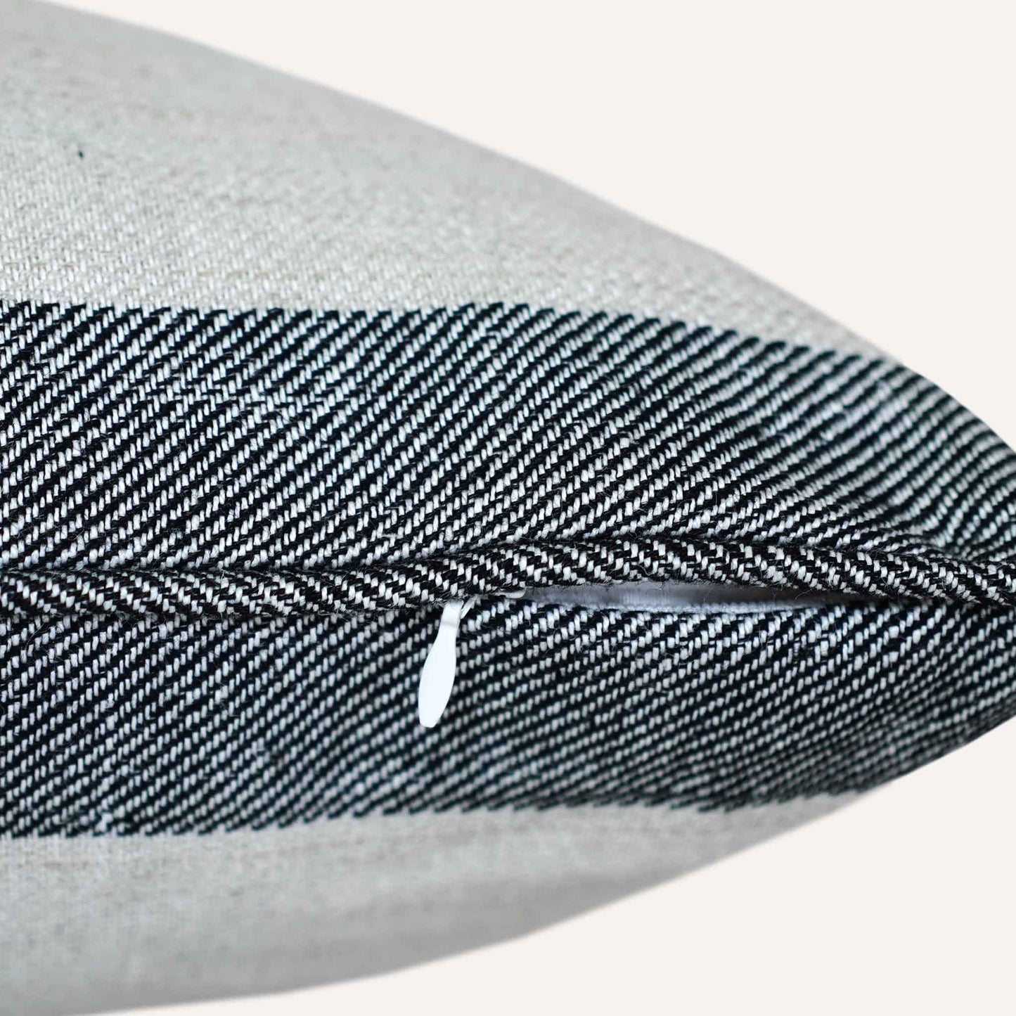 Close-up of the invisible zip on the striped grey bottom cushion.