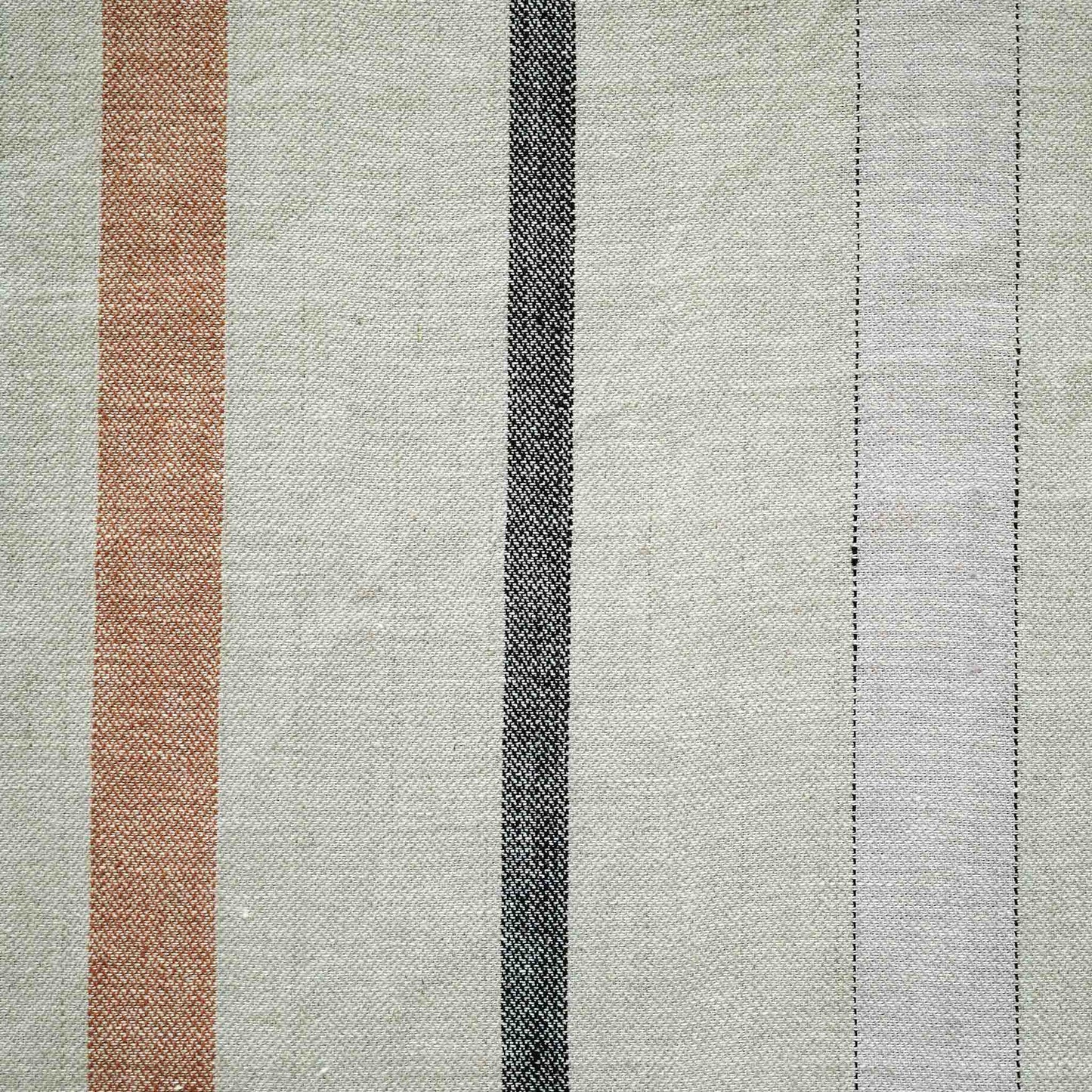 Red and grey stripes on grey background cushion with welt edges.
