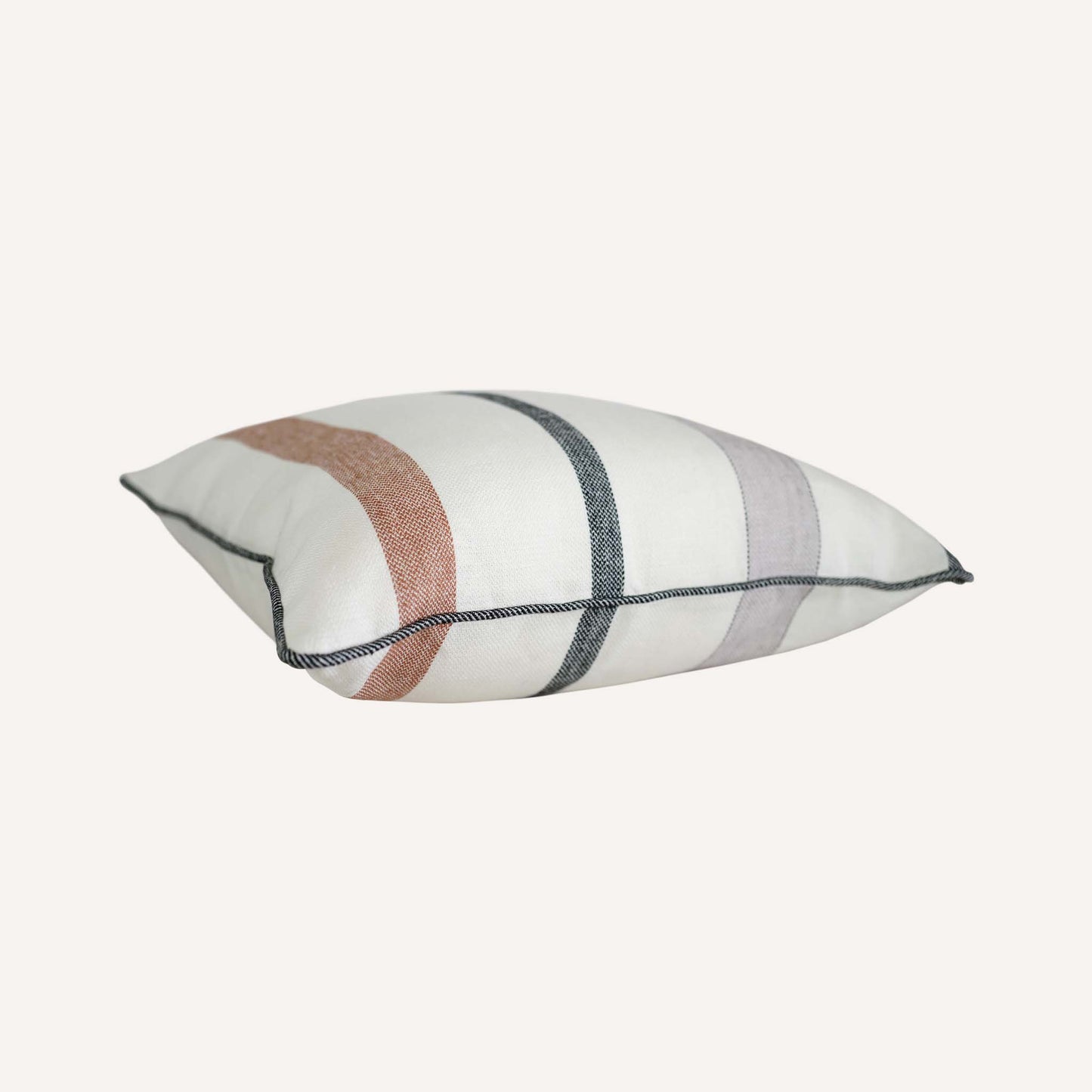 Red and grey stripes on white background cushion with welt edges.