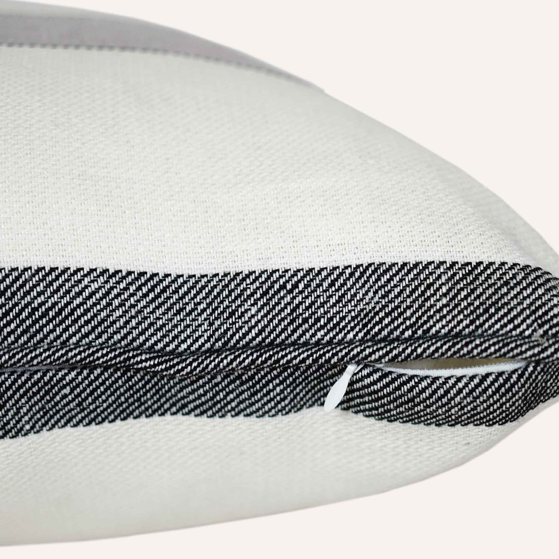 Close-up of the invisible zip on the striped grey bottom cushion.